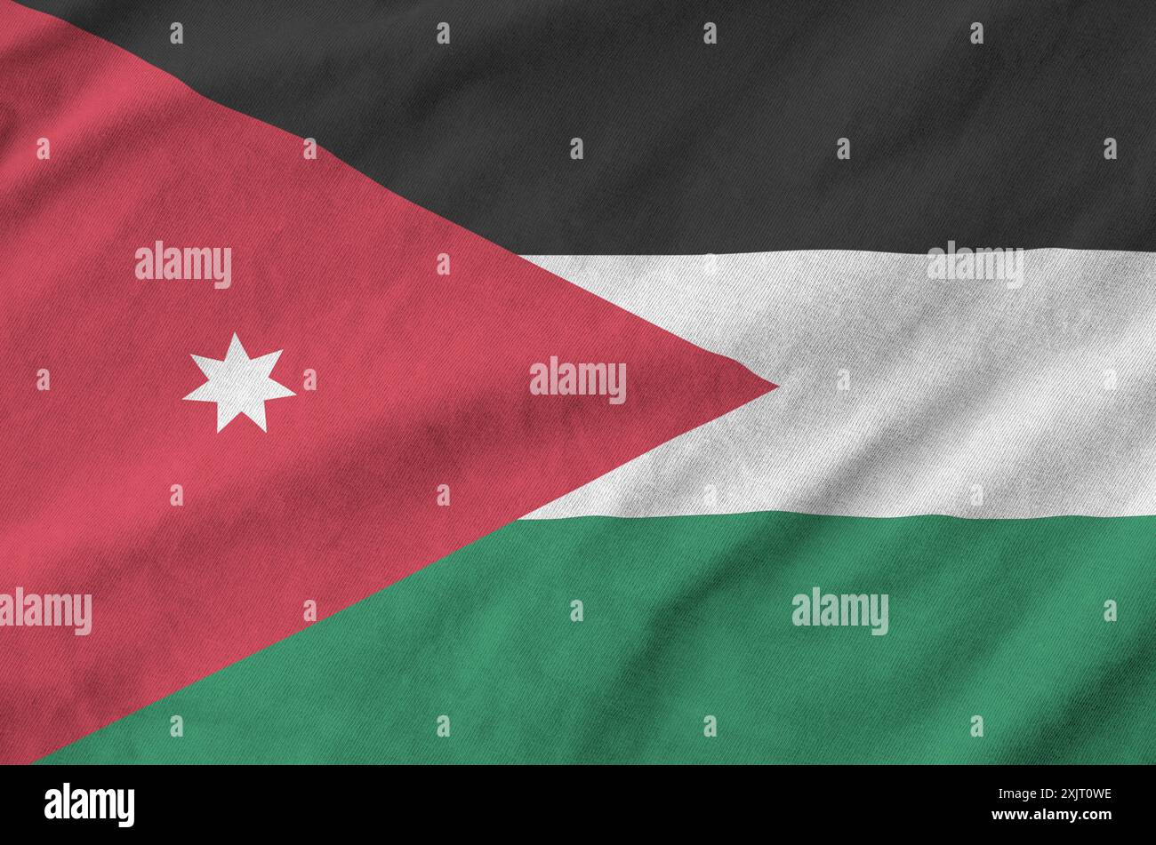 Drapeau Jordan représenté sur un tissu ondulé plié de vieux tissus en gros plan Banque D'Images