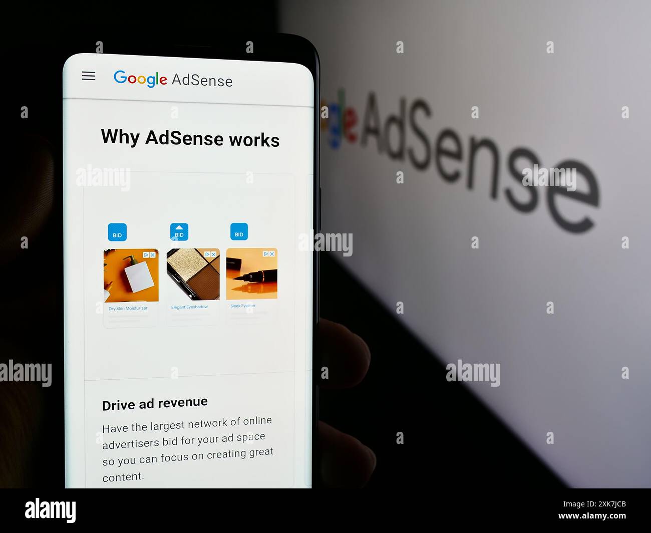 Personne tenant le téléphone mobile avec la page Web du programme de publicité en ligne Google AdSense devant le logo. Concentrez-vous sur le centre de l'écran du téléphone. Banque D'Images