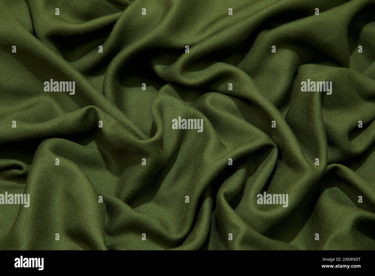 Fond de tissu vert. Texture de fond ondulée de tissu vert. Tissu vert tissu textile. Banque D'Images