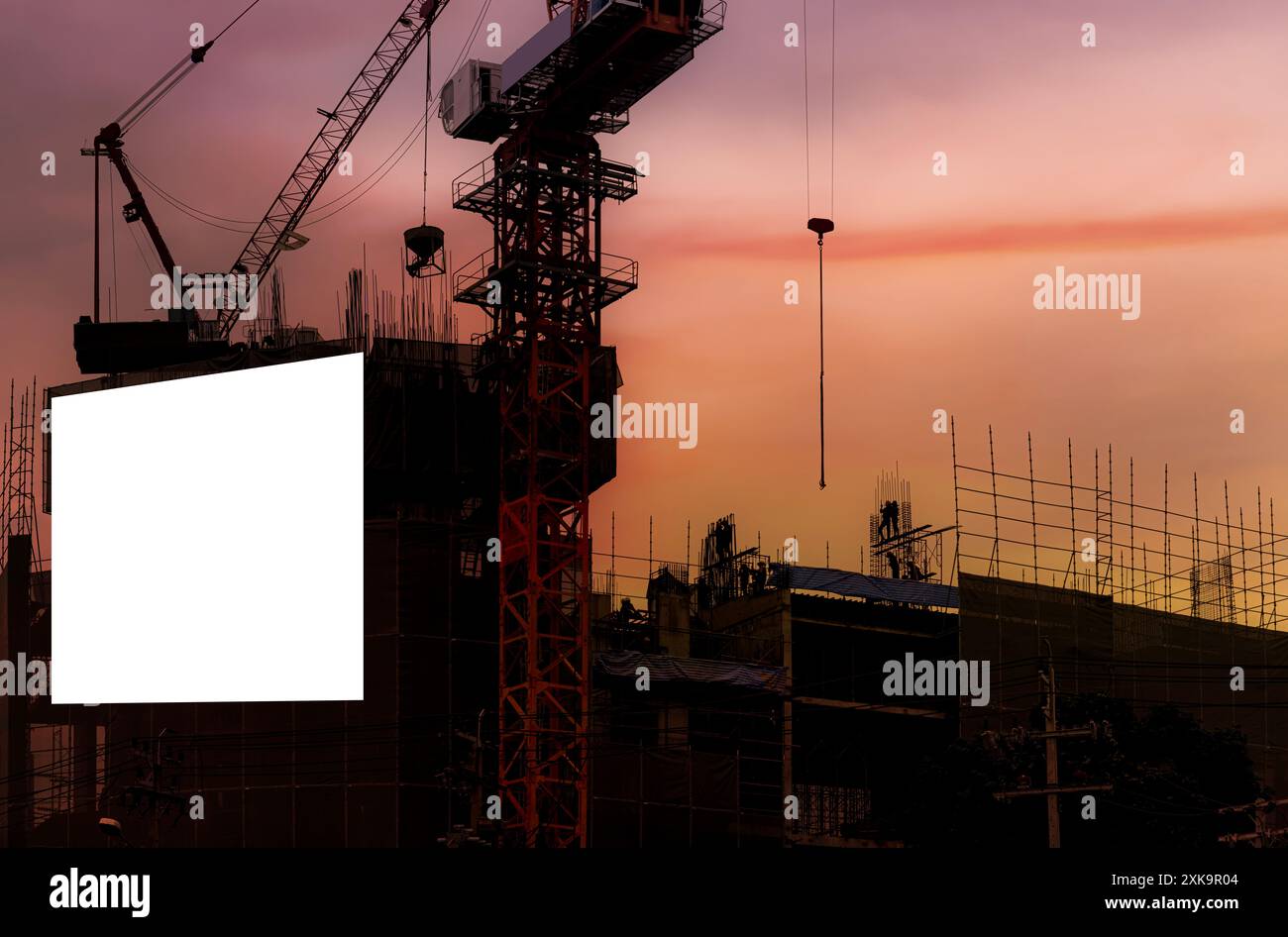 Bannière blanche vierge pour la publicité accrochée sur l'échafaudage du bâtiment moderne en construction. Un espace vide pour votre contenu. De beaux soleils Banque D'Images