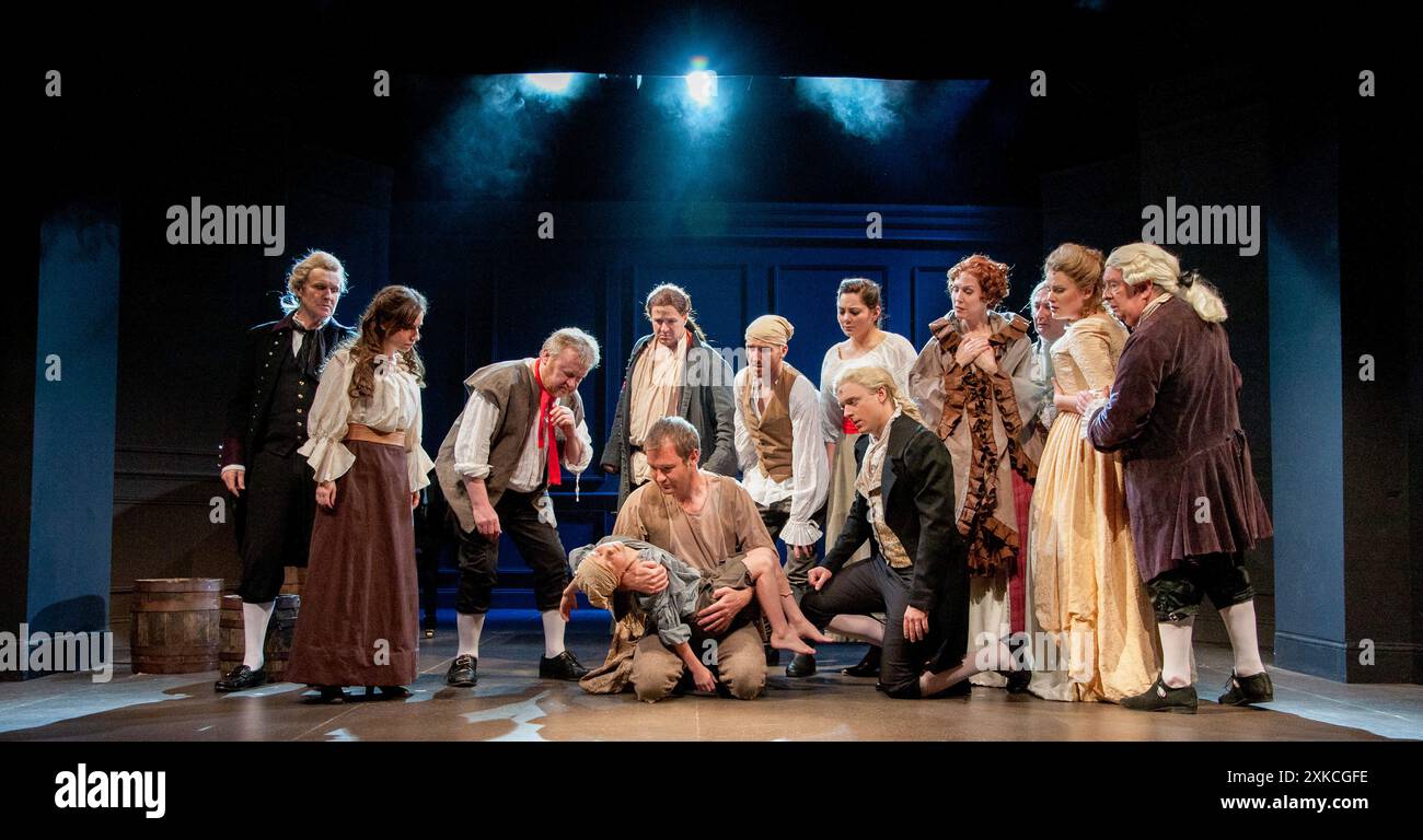 Kneeling centre : Neil Canfer (Gaspard - avec Tara Hayes dans le rôle d'Urchin Boy), Jonathan Ansell (Charles Darney) dans Un CONTE DE DEUX VILLES de Charles Dickens au Charing Cross Theatre, Londres WC2 17/04/2012 livre : Steven David Horwich & David Soames paroles : Steven David Horwich musique : David Pomeranz set design: Charlie Camm costumes : Suzi Lombardelli éclairage : Howard Hudson chorégraphie : Racky Plews réalisateur : Paul Nicholas Banque D'Images
