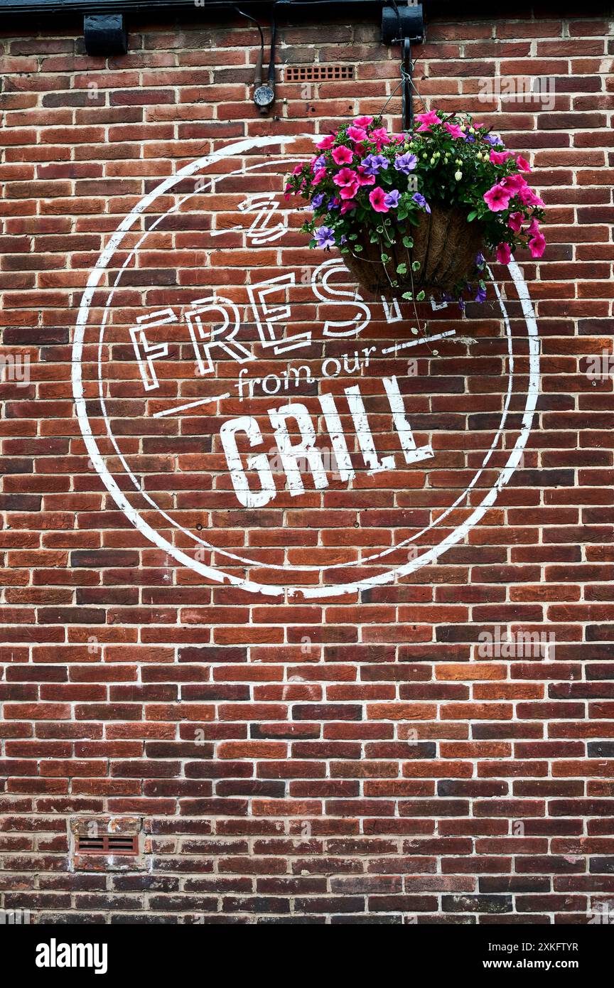 Logo de pubs sizzling et panier suspendu sur le mur du pub Banque D'Images