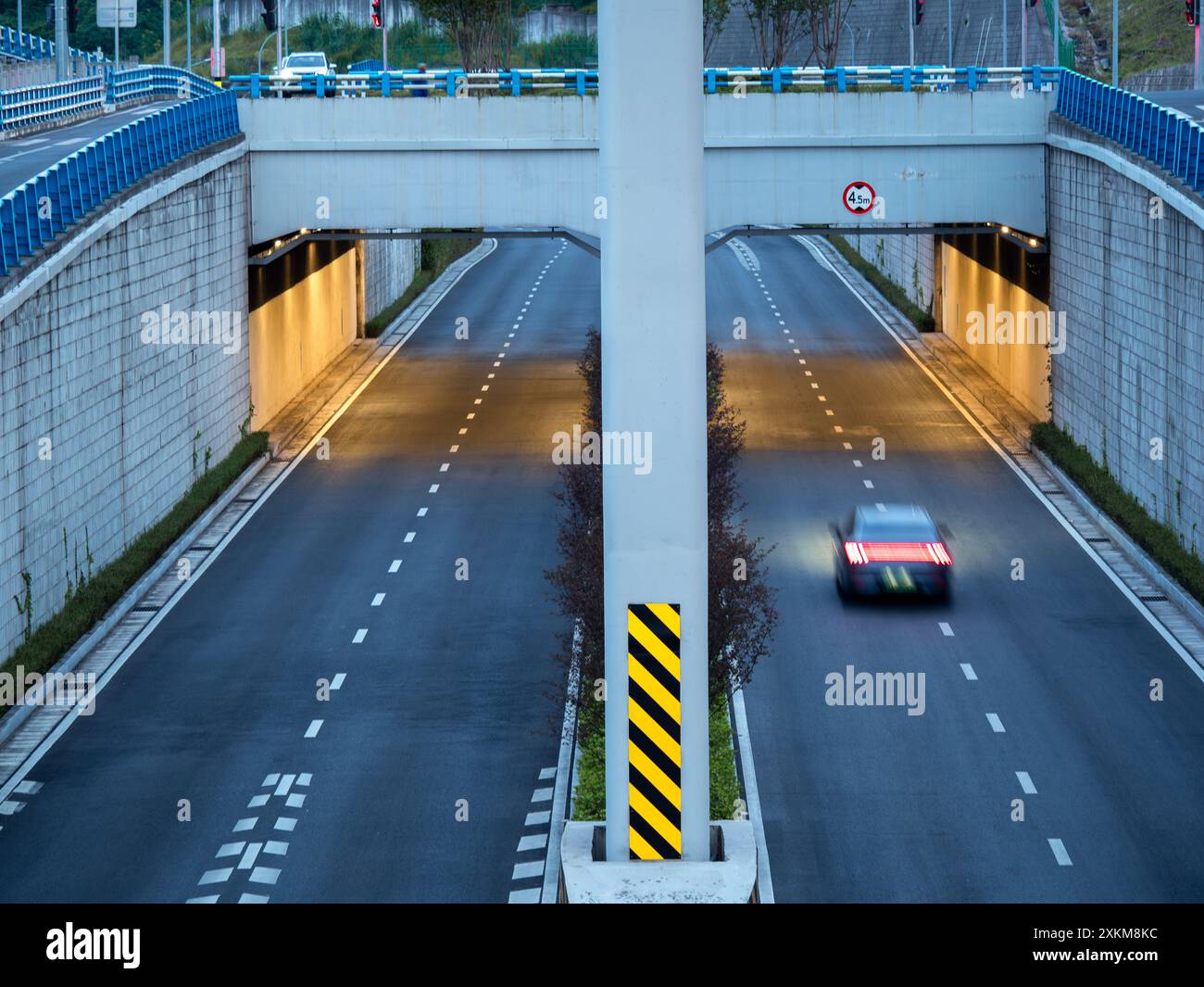 Vue à hauteur des yeux d'un interchange, le tunnel éclairé par une lumière chaude. Banque D'Images