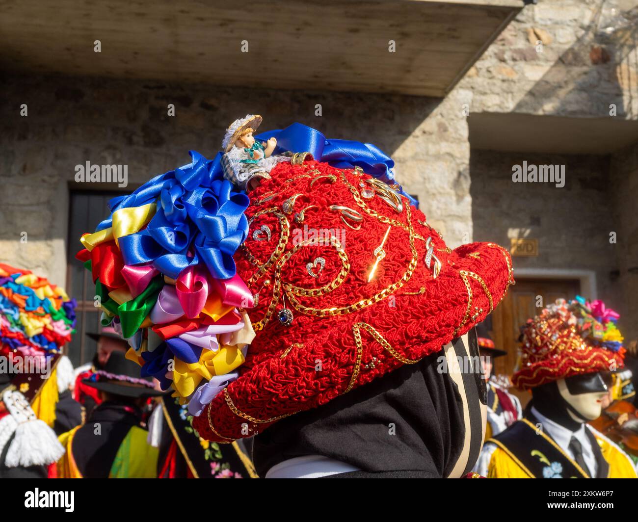 Balarì chapeau en feutre, recouvert d’un ruban rouge plié, orné de broderies, de bijoux de famille en or et de rubans multicolores en forme de noeud, carnaval Bagolino Banque D'Images