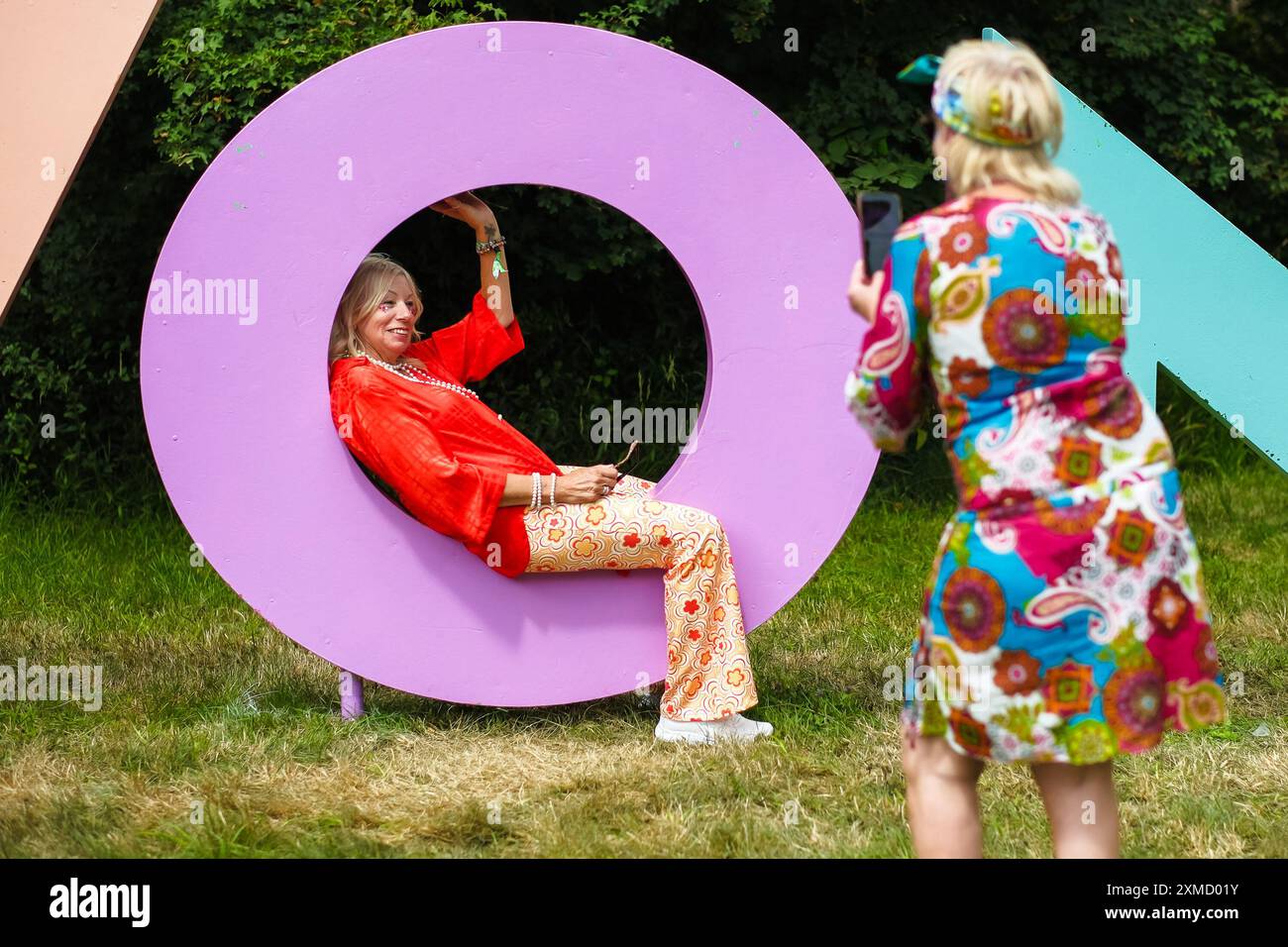 Malmesbury, Royaume-Uni. 27 juillet 2024. Une femme festivalière pose dans un panneau WOMAD vu au Womad - World of Music, Arts and Dance 2024. Photo de Julie Edwards./Alamy Live News Banque D'Images