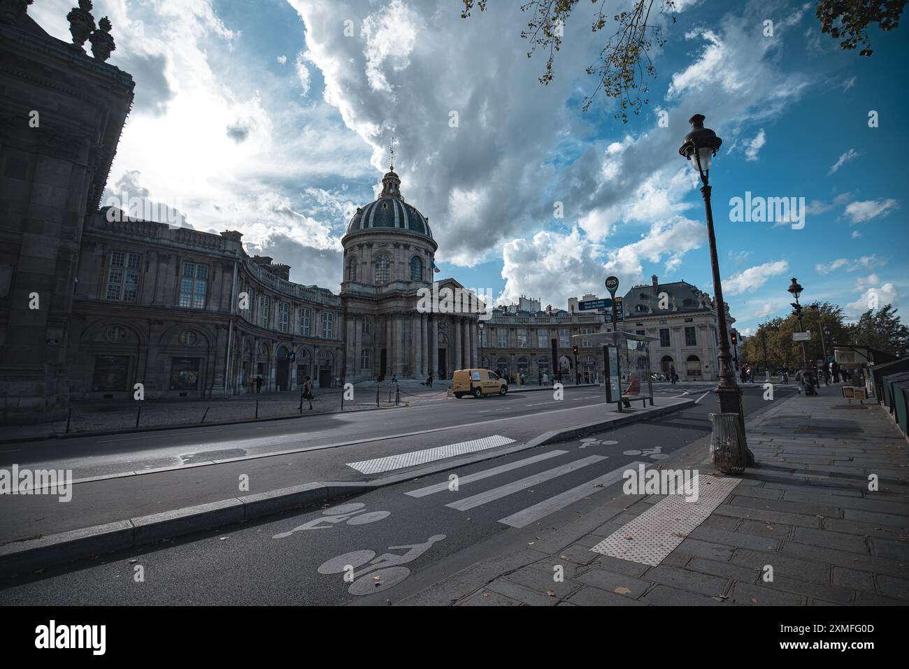 Paris, France - 19 octobre 2023 : vue sur une rue pavée de Paris, France, avec un grand bâtiment sur la gauche et un arrêt de bus sur la droite. Le Banque D'Images