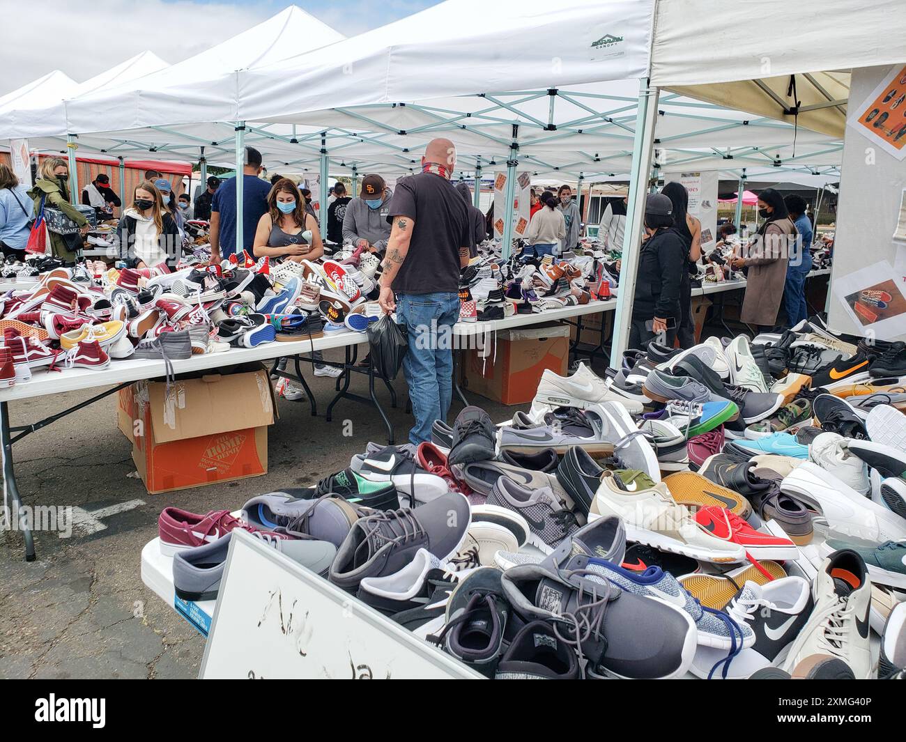 Los Angeles, Californie, États-Unis - 04-26-2021 : une vue de plusieurs personnes regardant autour de tables pleines de chaussures de tennis et de sport. Banque D'Images