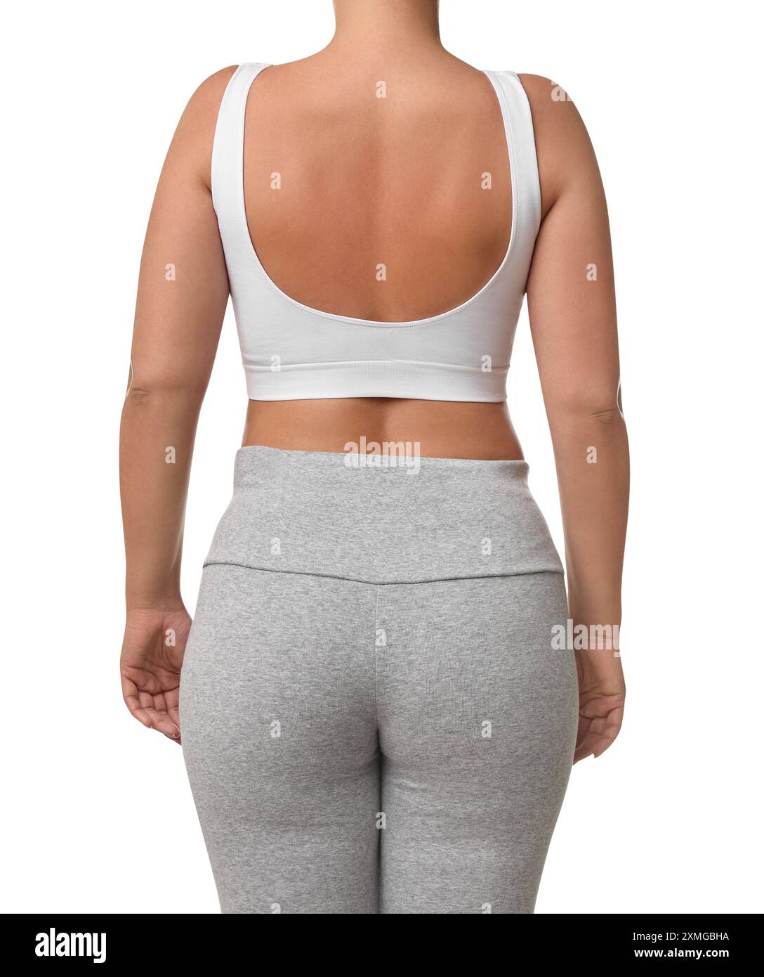 Femme portant un soutien-gorge de sport et des leggings sur fond blanc, vue arrière Banque D'Images