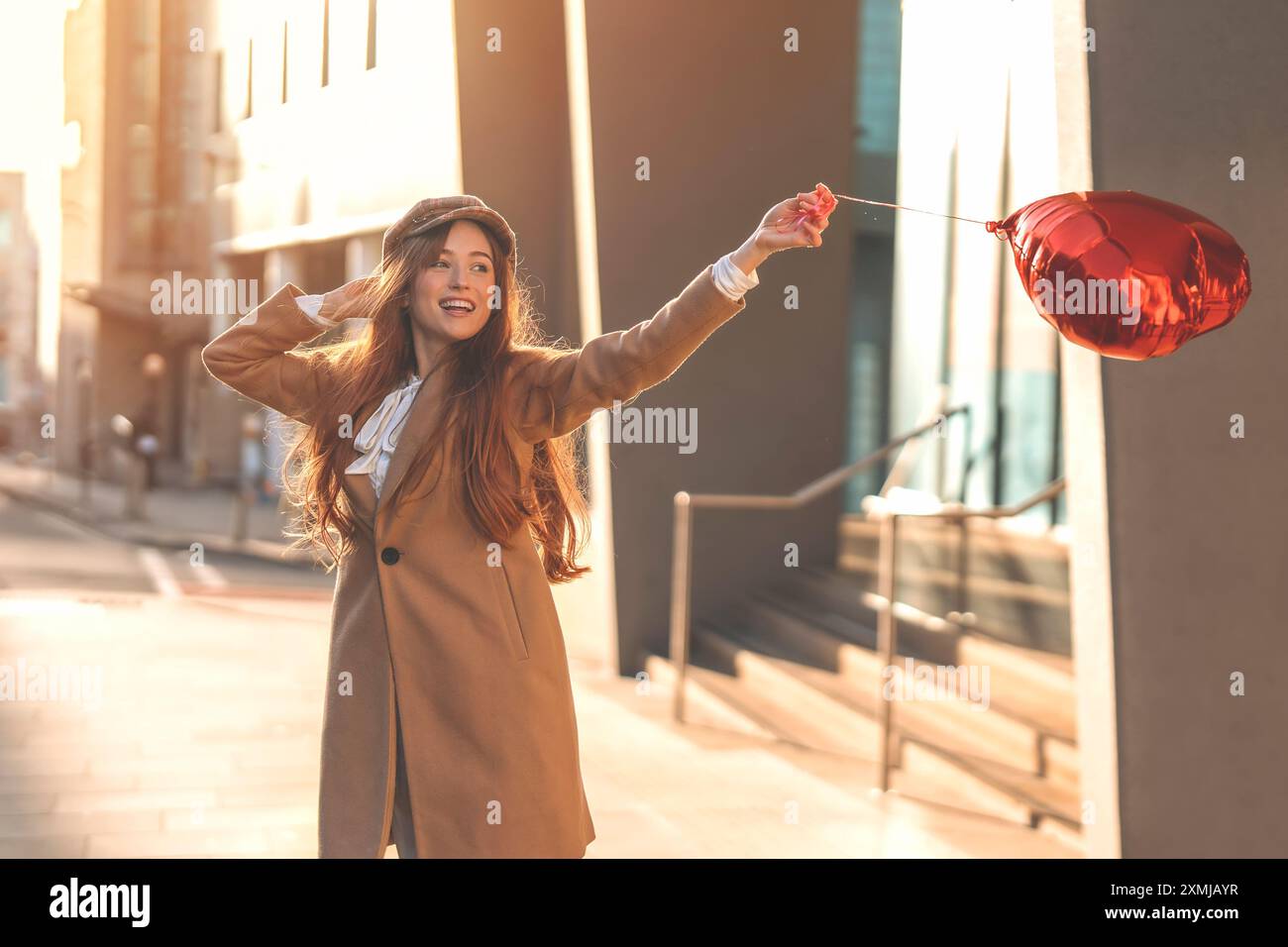 Jeune femme heureuse avec un ballon en forme de coeur tombant un amour, ayant une journée de plaisir, se promener dans la ville anglaise le printemps est dans l'air style de vie, tourisme, v Banque D'Images