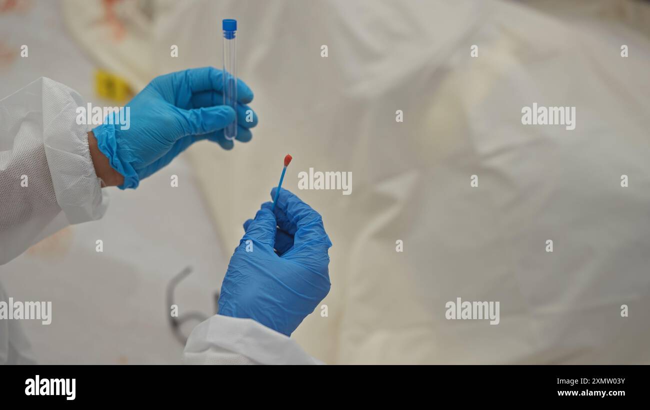 L'invention concerne une personne portant des gants de protection tenant un écouvillon d'échantillon de sang dans un environnement d'essai clinique. Banque D'Images