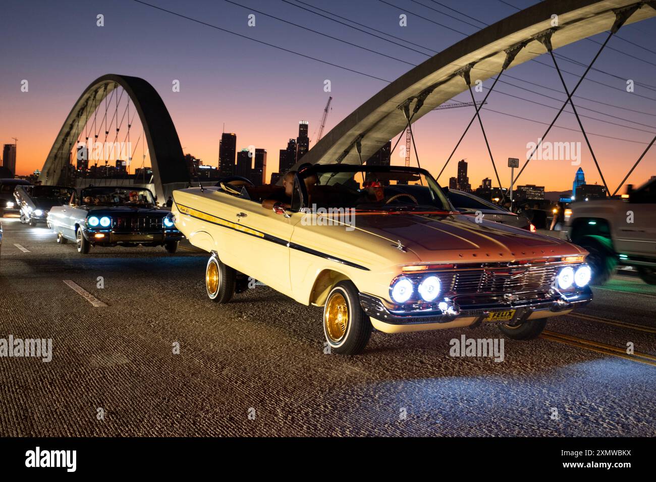 Voitures modifiées classiques à faible rider la nuit d'ouverture sur le viaduc de Sixth Street au crépuscule dans le centre-ville de Los Angeles Banque D'Images