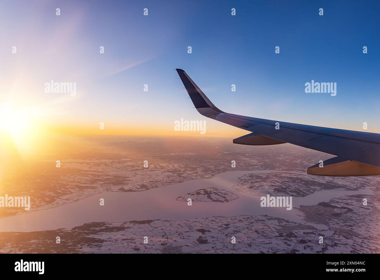 Avion volant bas au-dessus de montagnes enneigées et se préparant à atterrir à l'aéroport, vue depuis la fenêtre de l'avion de la turbine d'aile et de l'horizon Banque D'Images