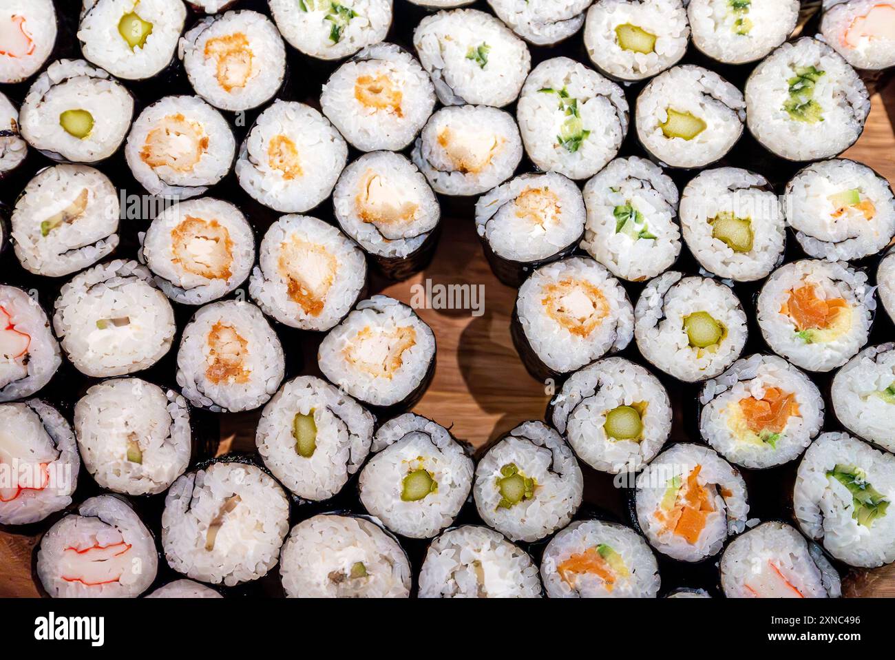 Beaucoup de différents types de sushis sur une assiette en bois. Banque D'Images