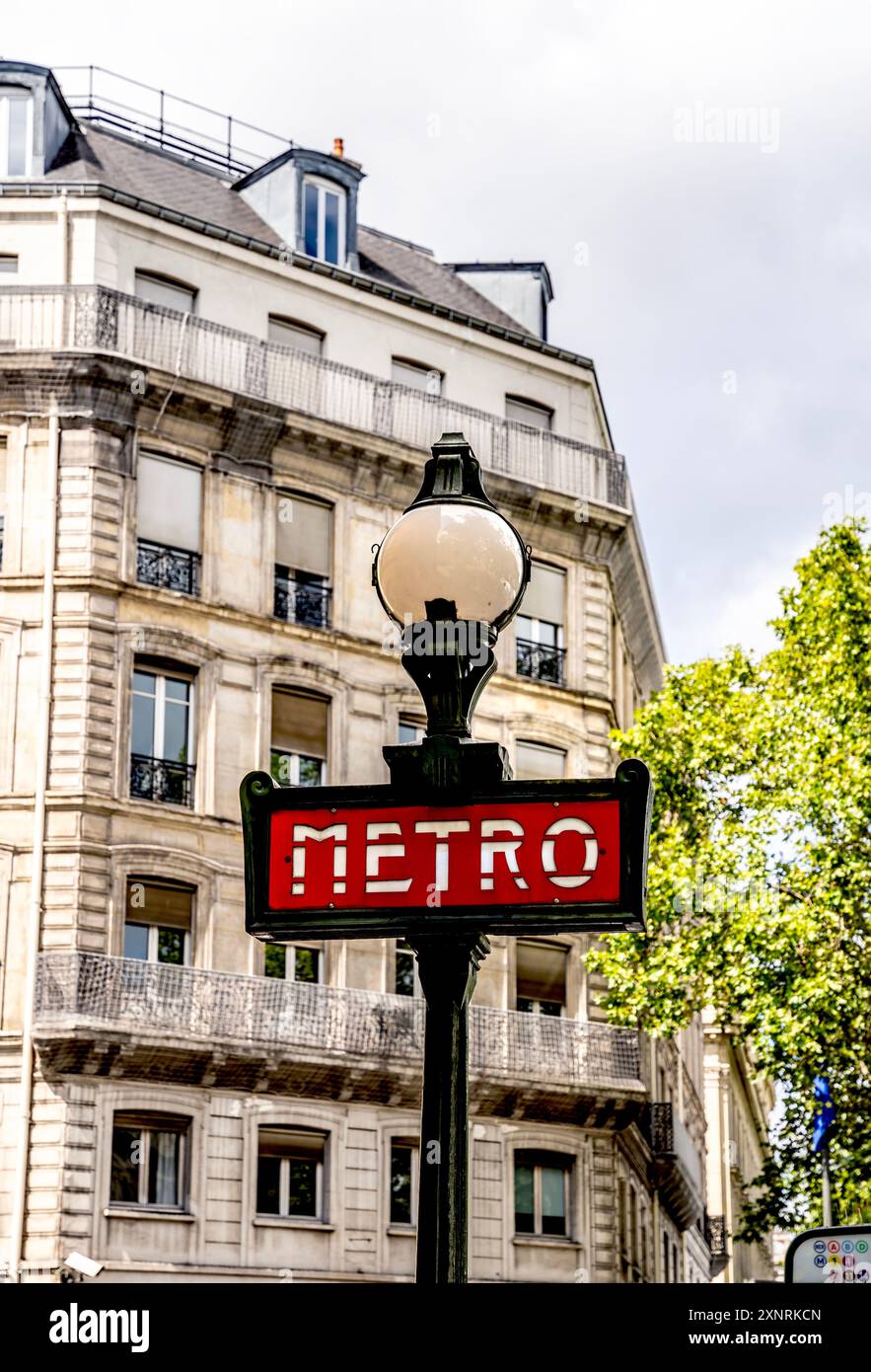 Vintage 'Metro' (métro) signe rouge avec lampadaire de lampadaire globe dans le centre-ville de Paris, France Banque D'Images