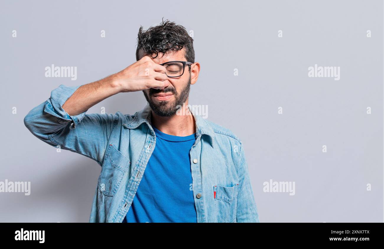 Personne avec douleur touchant le nez. Notion de douleur sinusale, Une personne avec douleur de pont nasal, un homme avec mal de tête de pont nasal Banque D'Images