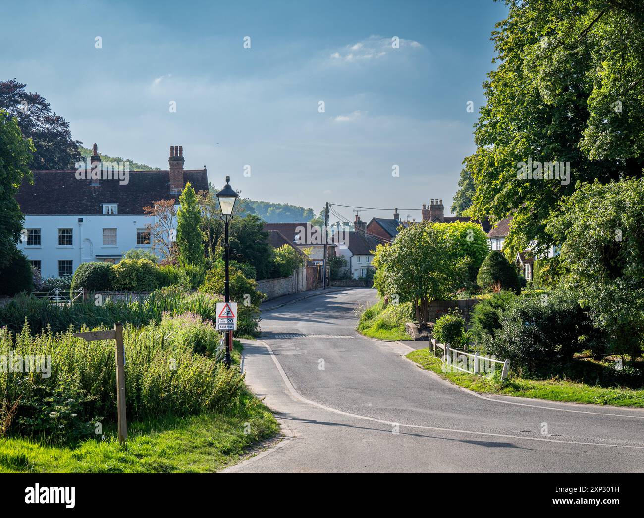 Une rue de village paisible à Buriton, Hampshire avec un panneau de limite de vitesse maximum de 20 km/h au premier plan. Banque D'Images