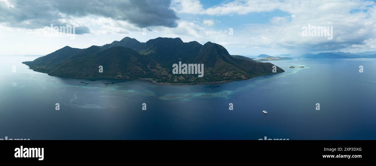 Un magnifique récif corallien entoure l'île volcanique de Pulau Pura en Indonésie. Cette zone est proche de Maumere, Flores, et abrite une grande biodiversité. Banque D'Images