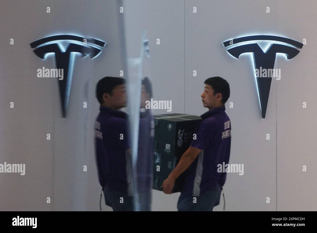 HANGZHOU, CHINE - 7 AOÛT 2024 - les gens passent devant le logo de Tesla à Hangzhou, province du Zhejiang, Chine, le 7 août 2024. Récemment, Tesla Motors (B Banque D'Images