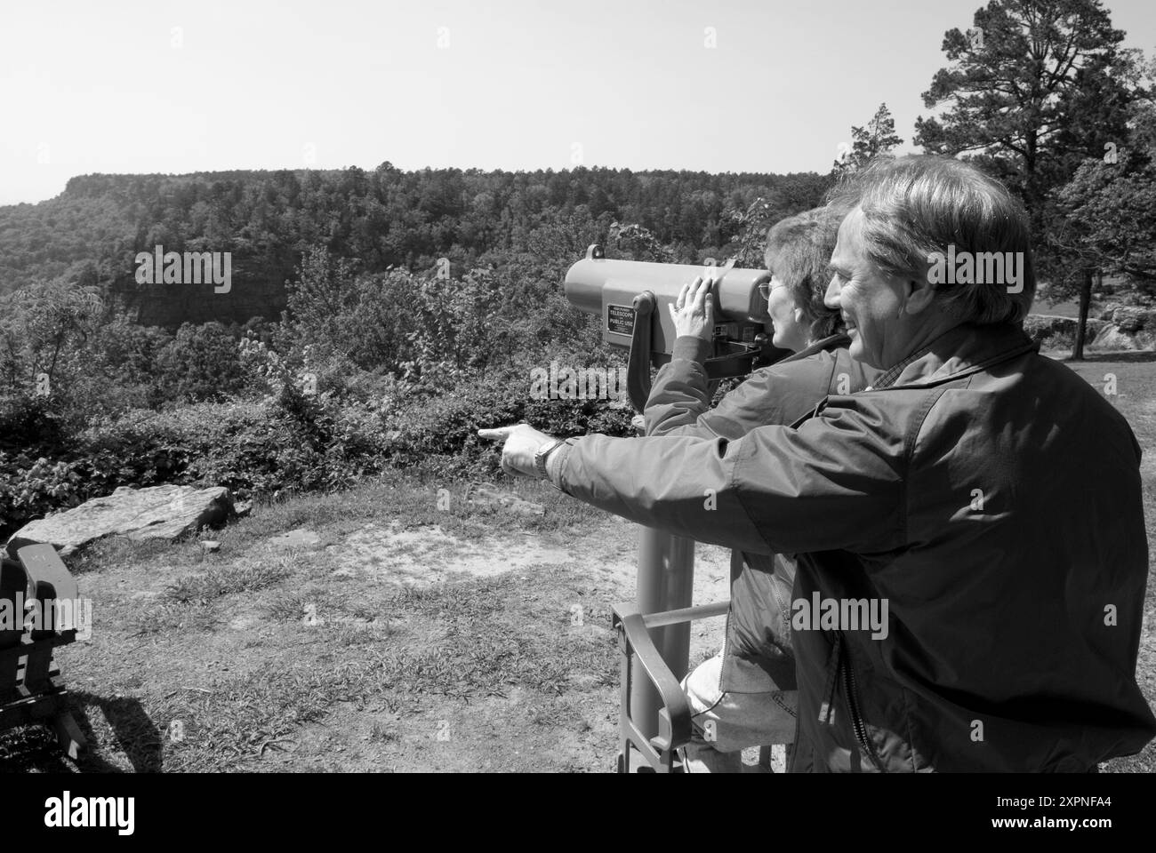 Couple caucasien (50-55) profitant de la vue à travers un télescope depuis Mather Lodge au petit Jean State Park, Arkansas, USA. Banque D'Images
