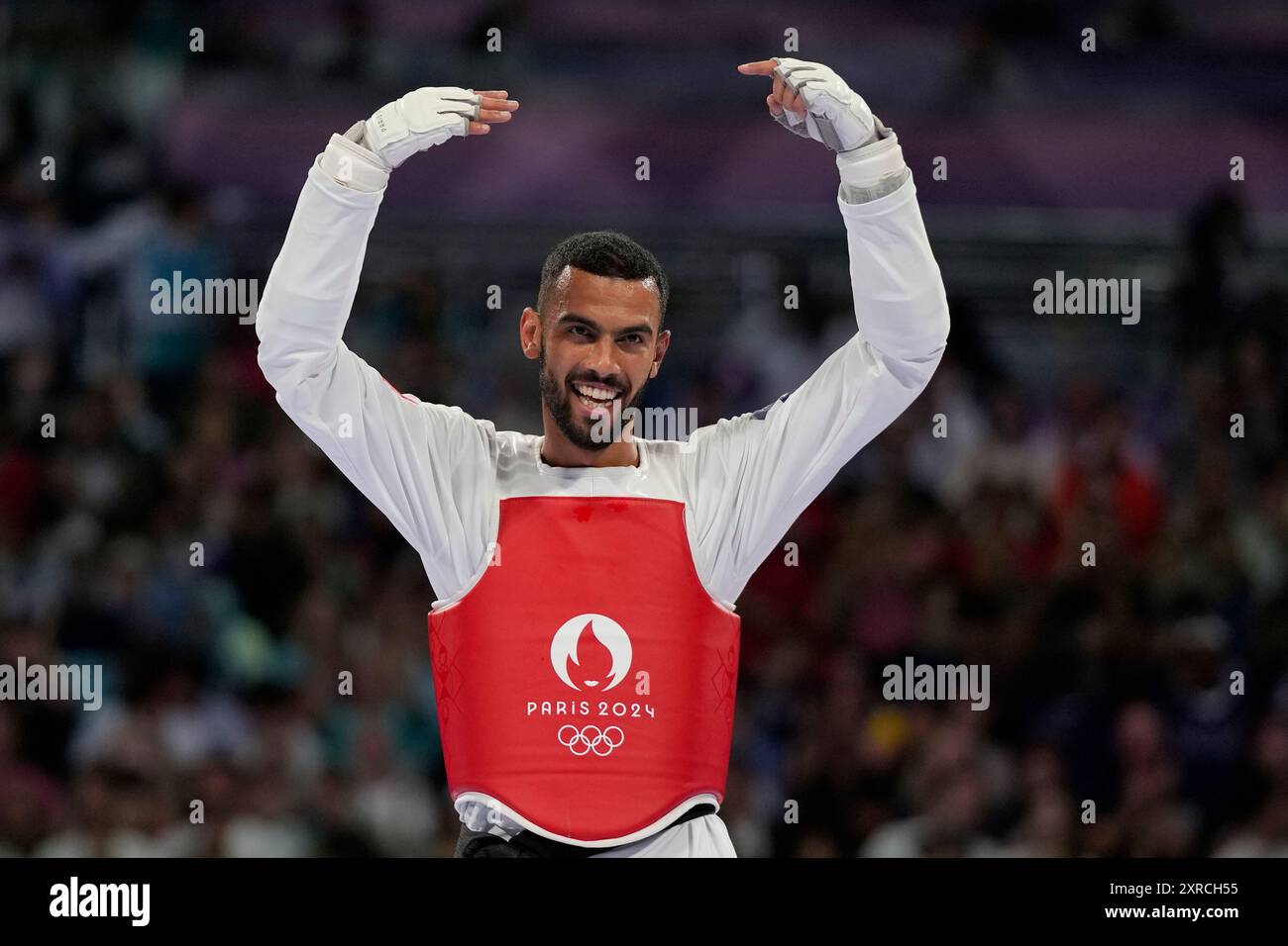 Tunisia's Firas Katoussi celebrates after winning the gold medal in a men's 80kg Taekwondo final match against Iran's Mehran Barkhordari during the 2024 Summer Olympics, at the Grand Palais, Friday, Aug. 9, 2024, in Paris, France. (AP Photo/Andrew Medichini) Banque D'Images