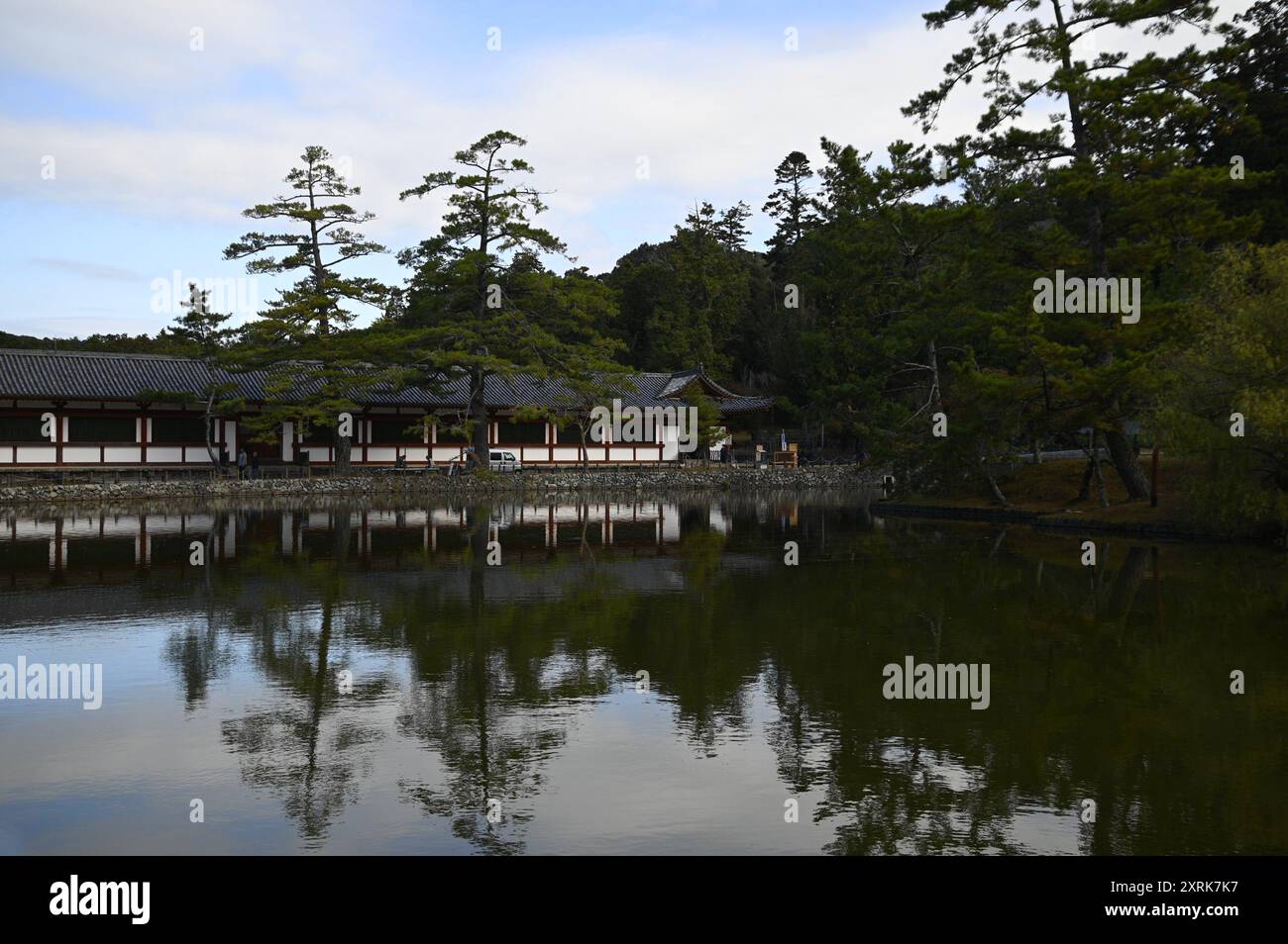 Paysage avec vue panoramique sur Higashi Kairo le couloir couvert oriental du temple bouddhiste Tōdai-ji sur l'étang Kagami-IKE à Nara, Kansai Japon. Banque D'Images