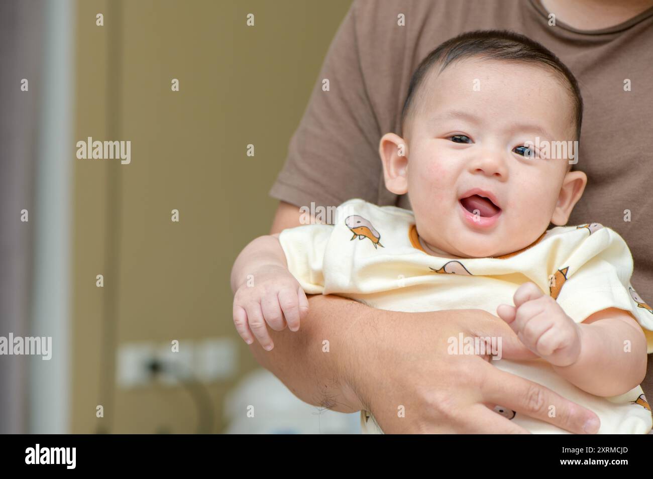 joli sourire de bébé joyeux dans la main de la mère. le concept du nourrisson emotion Banque D'Images