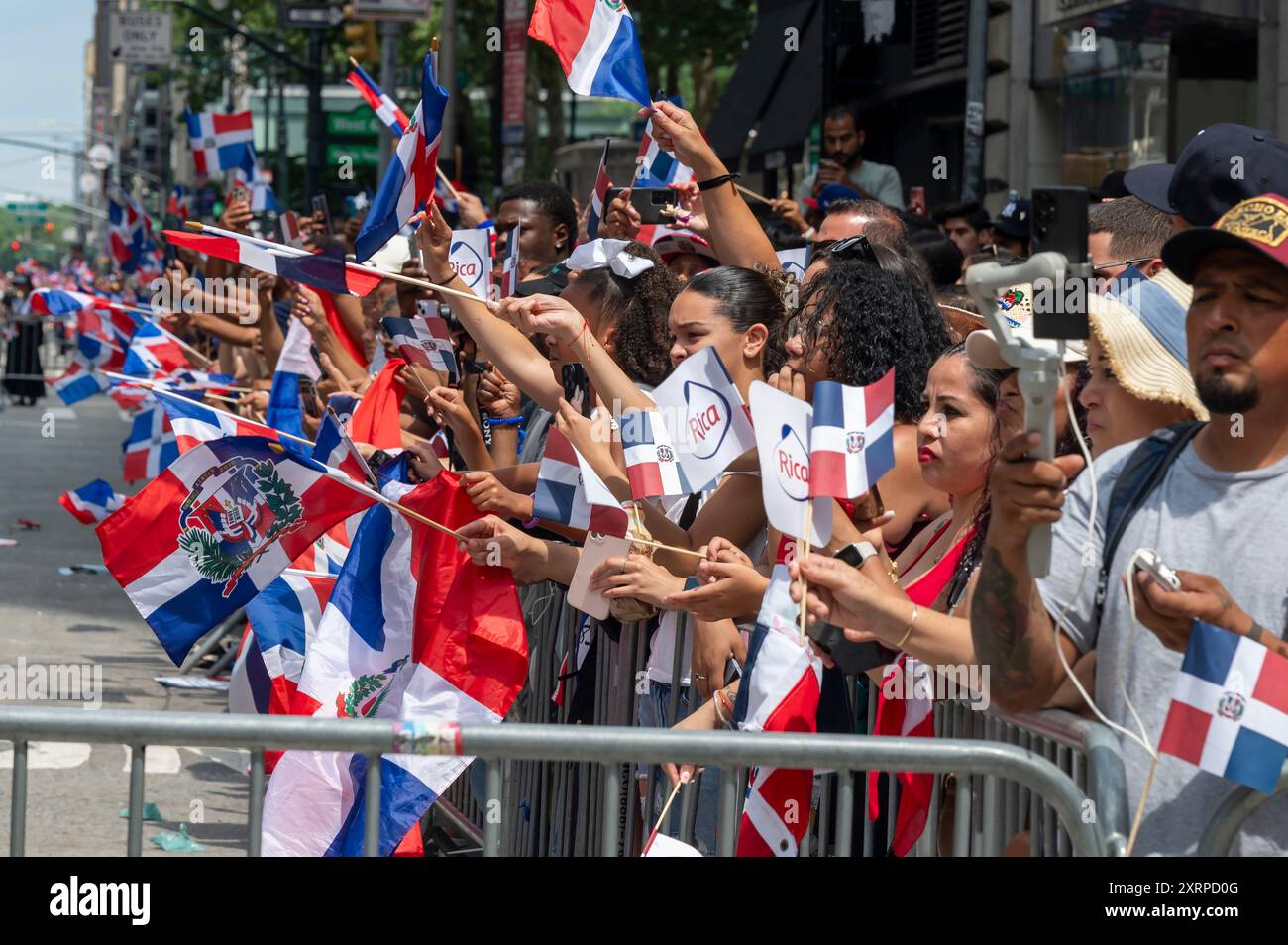 New York, États-Unis. 11 août 2024. NEW YORK, NEW YORK - 11 AOÛT : les spectateurs avec des drapeaux de la République dominicaine regardent les marcheurs à la défilé de la fête dominicaine sur la 6e Avenue le 11 août 2024 à New York. Le défilé de la fête nationale dominicaine a célébré 42 ans de marche sur la Sixième Avenue à Manhattan. Le défilé célèbre la culture dominicaine, le folklore et les traditions. Crédit : Ron Adar/Alamy Live News Banque D'Images