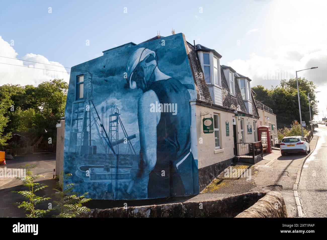 Une fresque massive sur le côté du pub du village à Comrie Fife. Le tableau représente un mineur et la mine de charbon Comrie de l'artiste Donna Forrester Banque D'Images