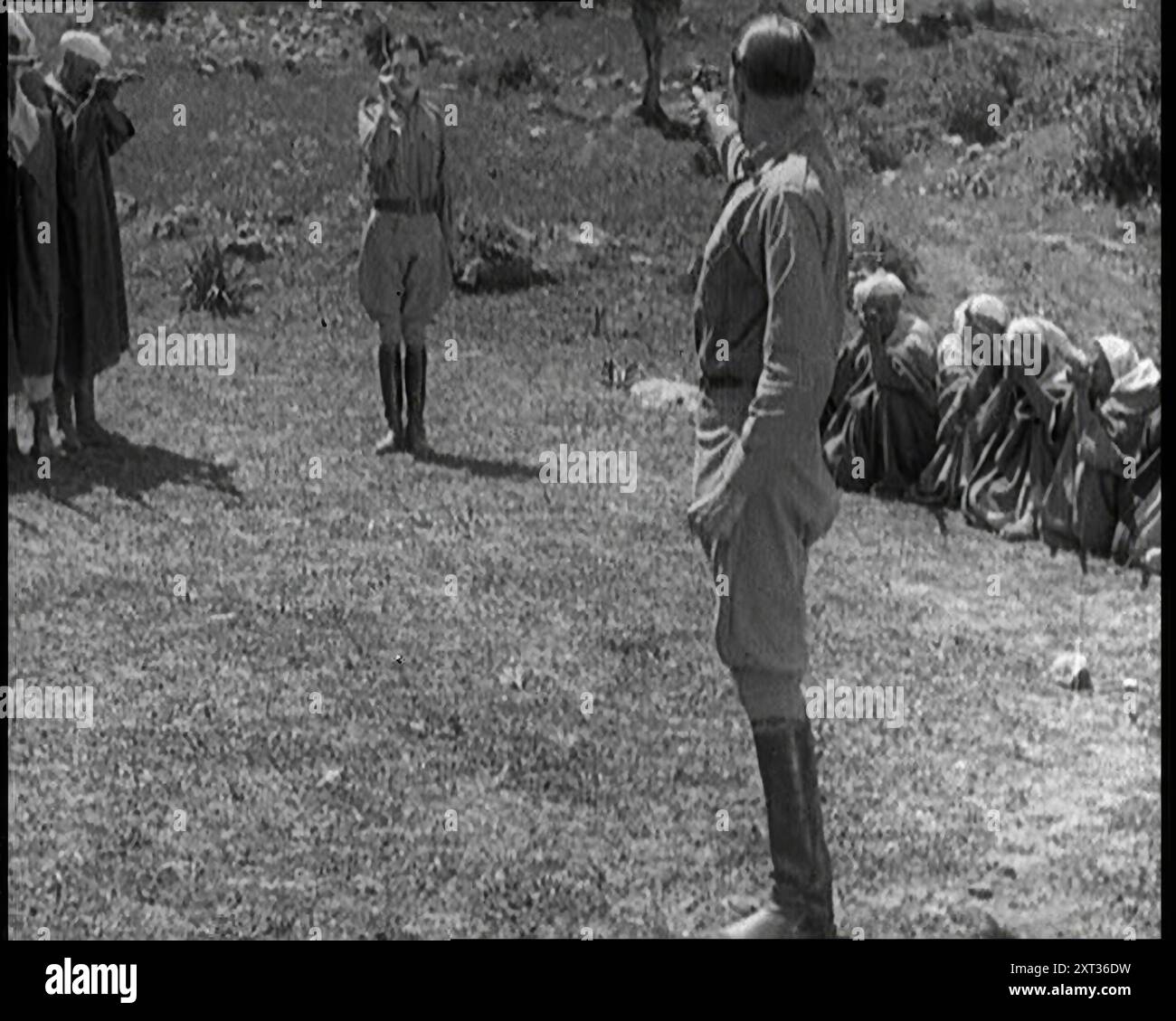 Scène du long métrage 'le Cheikh Blanc'. Deux acteurs dépeignant des soldats face à face dans un duel avec des pistolets dans leurs mains, années 1920 'Guerre dans le désert, avec tous ses maux de cruauté primitive, soif et intrigue, frère contre frère, ami contre ami... mais malgré les Rifs, c'était agréable sur place sous le soleil chaud en Afrique'. The White Sheik (1928), également connu sous le nom de King's Mate, est un film d'aventure muet britannique réalisé par Harley Knoles et mettant en vedette Lillian Hall-Davis, Jameson Thomas et Warwick Ward. De "Time to Remember - came the Dawn", 192 Banque D'Images