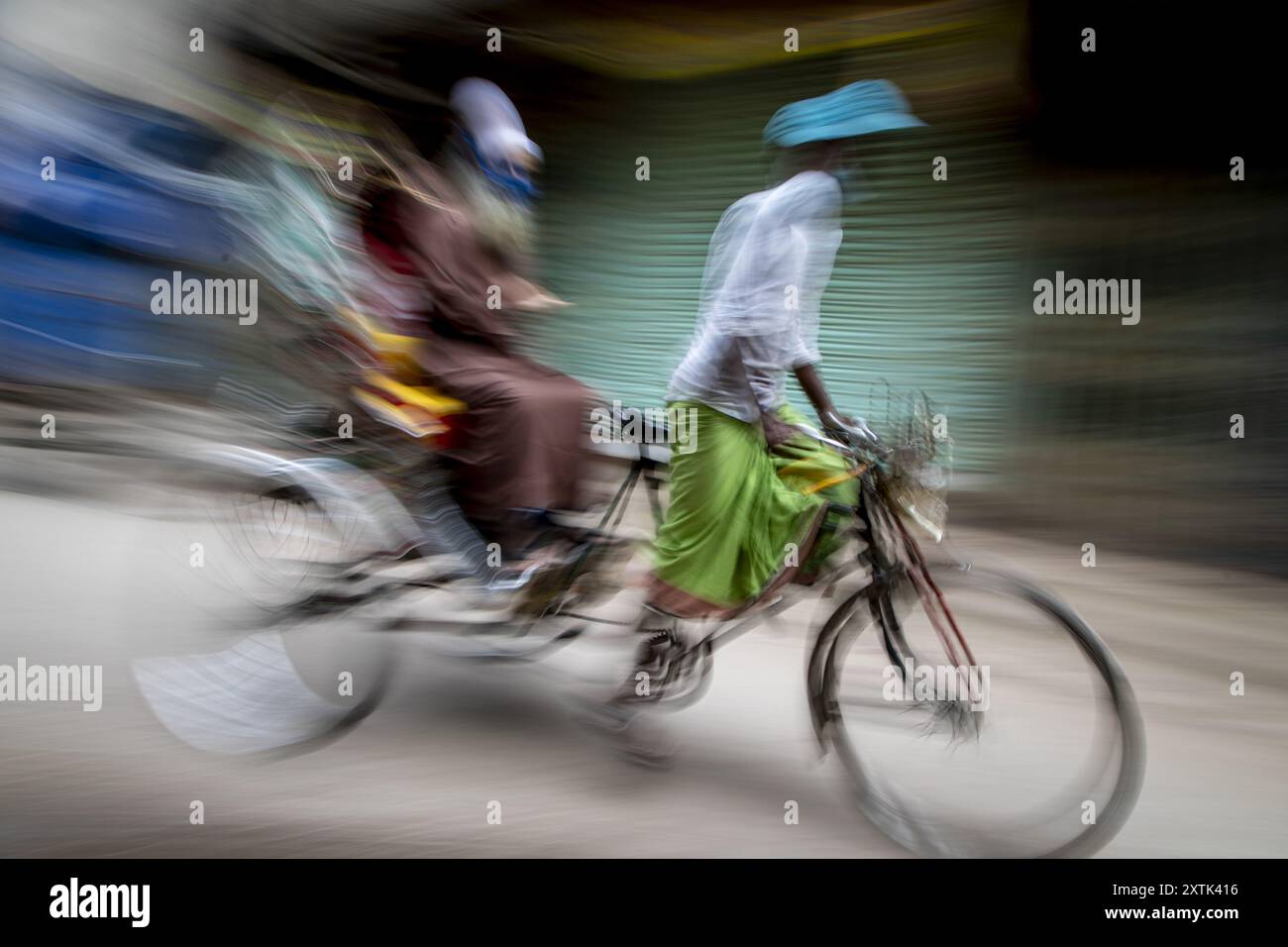 Des tireurs de pousse-pousse dans les rues de Puran Dhaka - Old Dhaka au Bangladesh. Les pousse-pousse sont des tricycles à pédale, mais utilisés pour être tirés à la main, d'où 'arrache-pousse'. Aujourd'hui, beaucoup de pousse-pousse sont même convertis pour être alimentés par moteur électrique. Banque D'Images