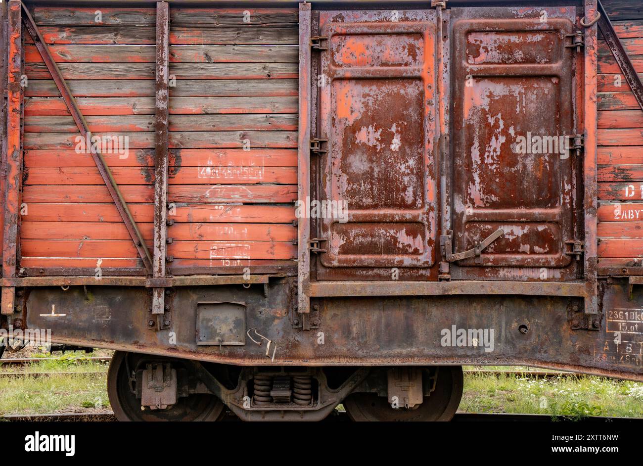 Vue détaillée d'un vieux fond de porte rouge de voiture de train à vapeur rouillé Banque D'Images