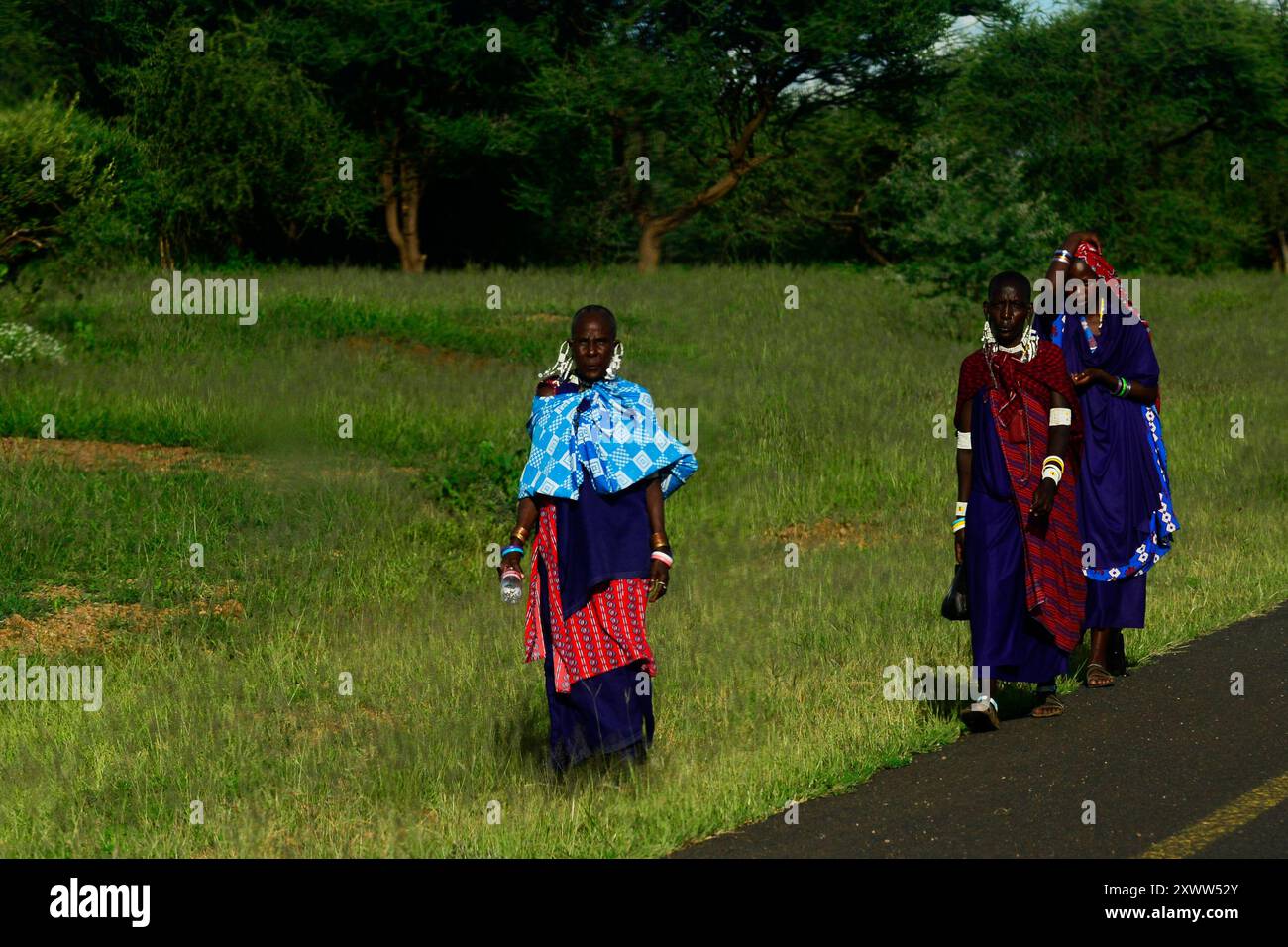 Femmes Massaï marchant le long de la route dans le nord de la Tanzanie. Banque D'Images