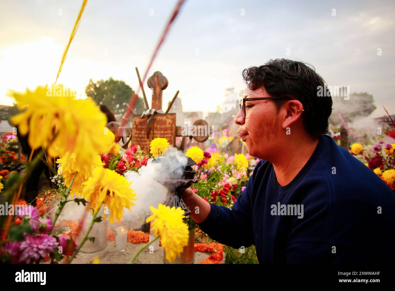 Ciudad de Mexico, Mexique - 2 novembre. 2023 : femme allume de l'encens pendant le jour des morts à Mixquic Banque D'Images