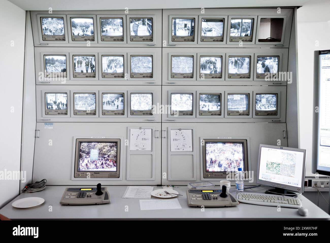 Cette image représente un système de surveillance dans la salle de contrôle d'un stade utilisé pour le contrôle des foules et la gestion de la sécurité. Pris lors d'un match de football au Niedersachsenstadion à Hanovre, en 2011, il souligne l'importance de surveiller l'activité des supporters pour la sécurité. Banque D'Images