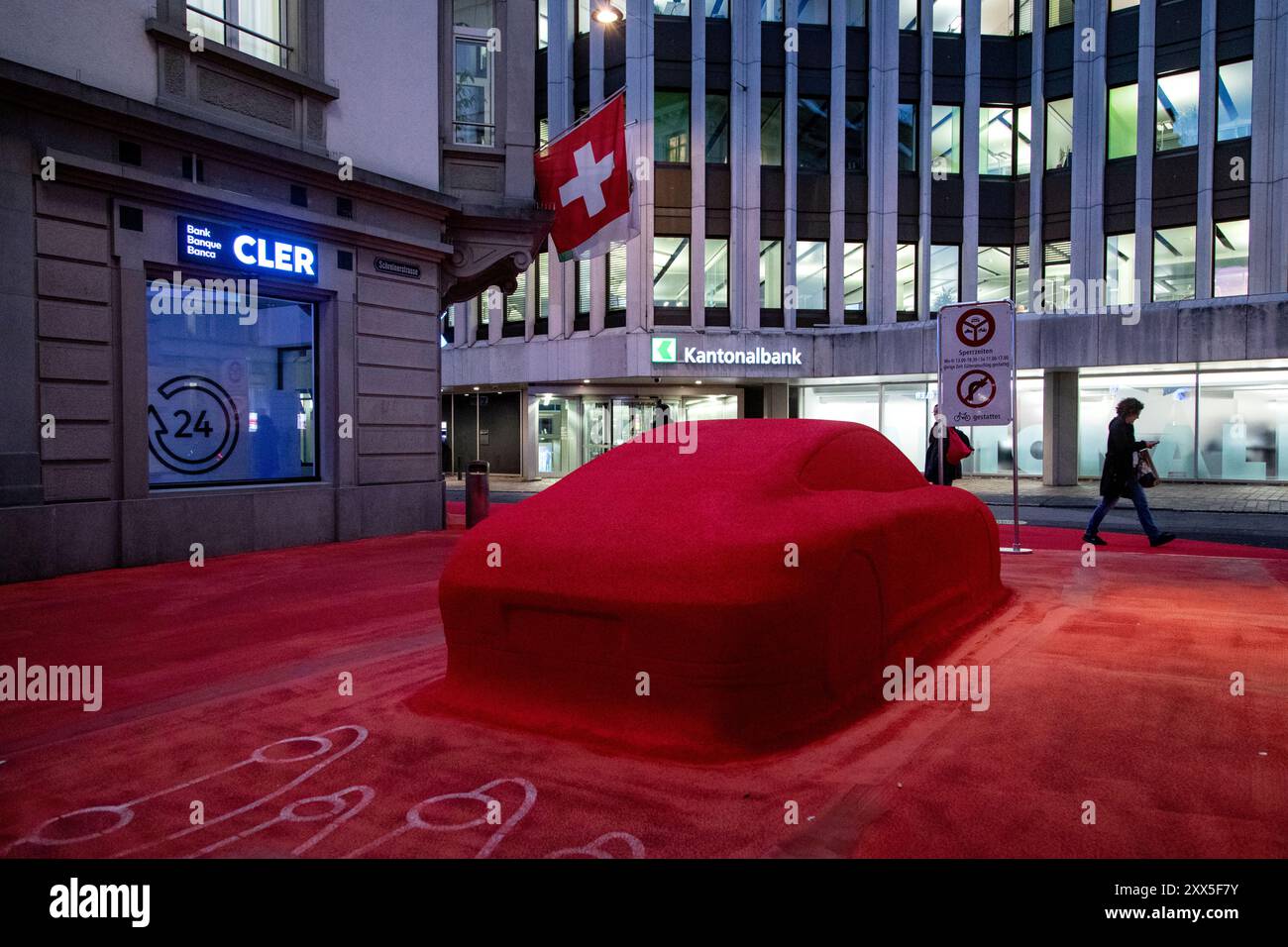 Gater og fortau rundt hovedkvarteret til den sveitsiske banken Raiffeisen er rødt, som i logoen til banken. En rød skulptur av en Porsche hører også med. Kunstneren Pippilotti Rist og designeren Carlos Martinez står bak installasjonen pulært kalt 'den Røde Plass'. Den lille byen St Gallen ved Bodensjøen i Sveits ligger naturaskjønt til, og har beitende kyr inne i byen. Byen er også et svært viktig finanssenter, hvor blant annet den sveitsiske banken Raiffeisen har hovedkvarter. Den huser også en av verdens beste universiteter. Université de Saint-Gall har vært et av de mest prestisjefylte stede Banque D'Images