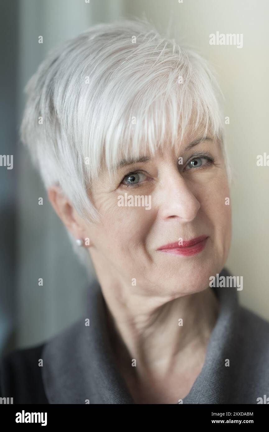 Portrait d'une femme âgée bien soignée avec les cheveux courts gris et un léger sourire. Vue caméra Banque D'Images