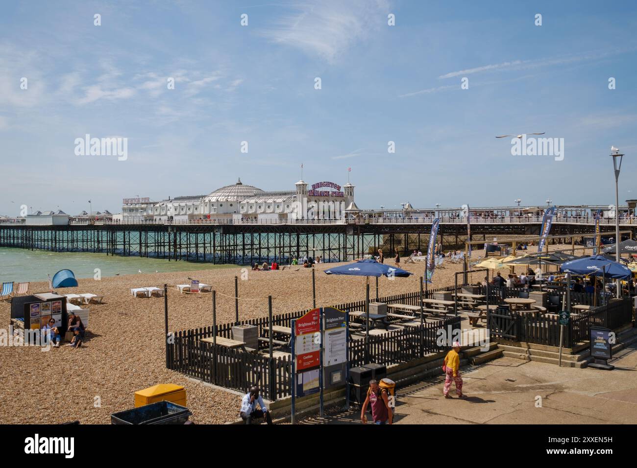Une vue de paysage de Brighton Pier prise du côté gauche de la jetée montrant la plage et le café au premier plan. Banque D'Images