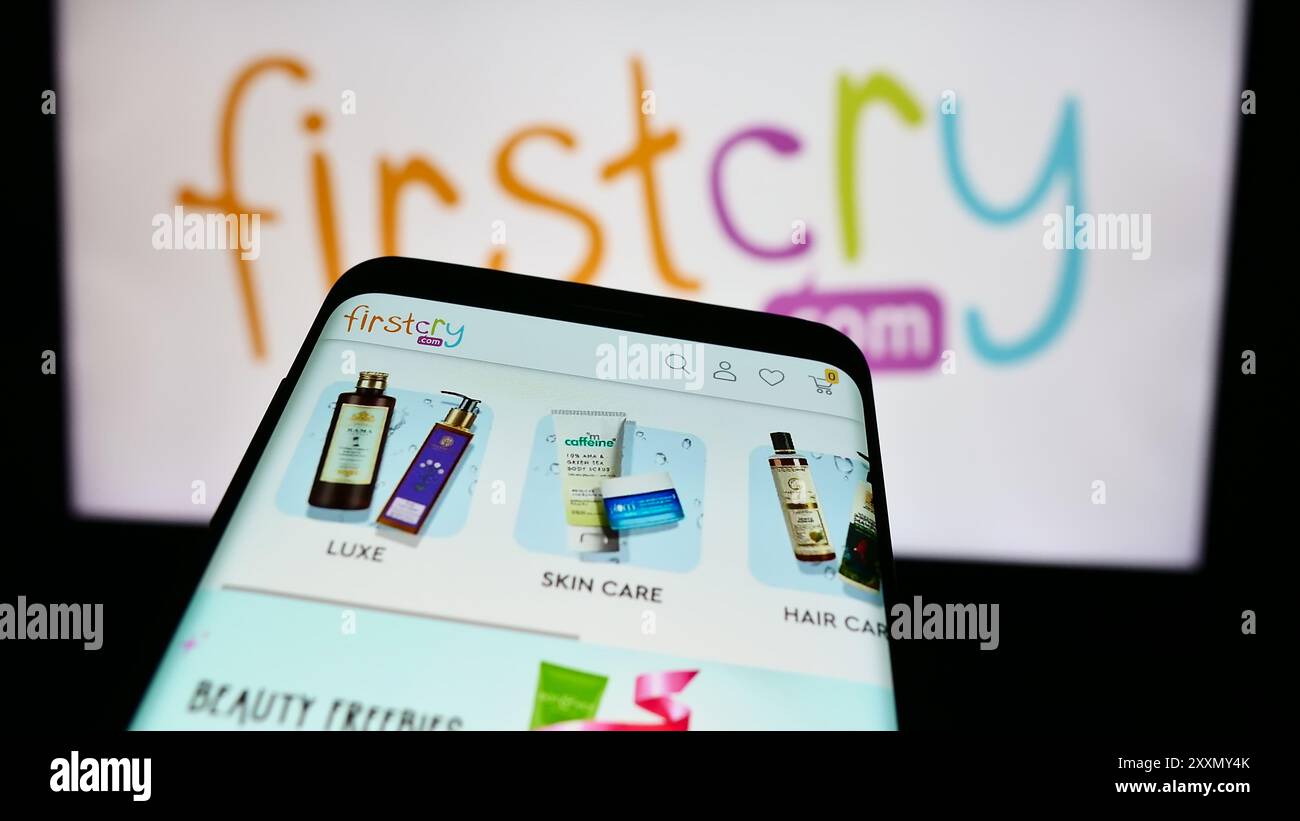 Smartphone avec site Web de la société de commerce électronique Indian Kid Products FirstCry.com devant le logo de l'entreprise. Concentrez-vous sur le coin supérieur gauche de l'écran du téléphone. Banque D'Images