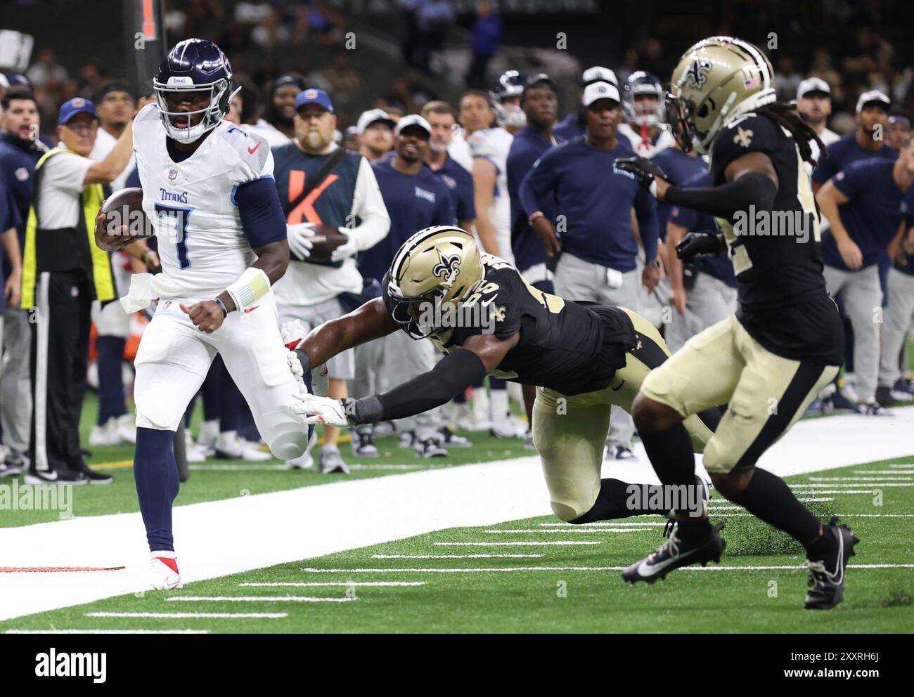 La Nouvelle-Orléans, États-Unis. 25 août 2024. Isaiah Foskey (55 ans) tente de forcer le quarterback des Titans du Tennessee, Malik Willis (7 ans), hors limites lors d'un match de pré-saison de la National Footbal League au Caesars Superdome le dimanche 25 août 2024 à la Nouvelle-Orléans, en Louisiane. (Photo de Peter Forest/SipaUSA) crédit : Sipa USA/Alamy Live News Banque D'Images