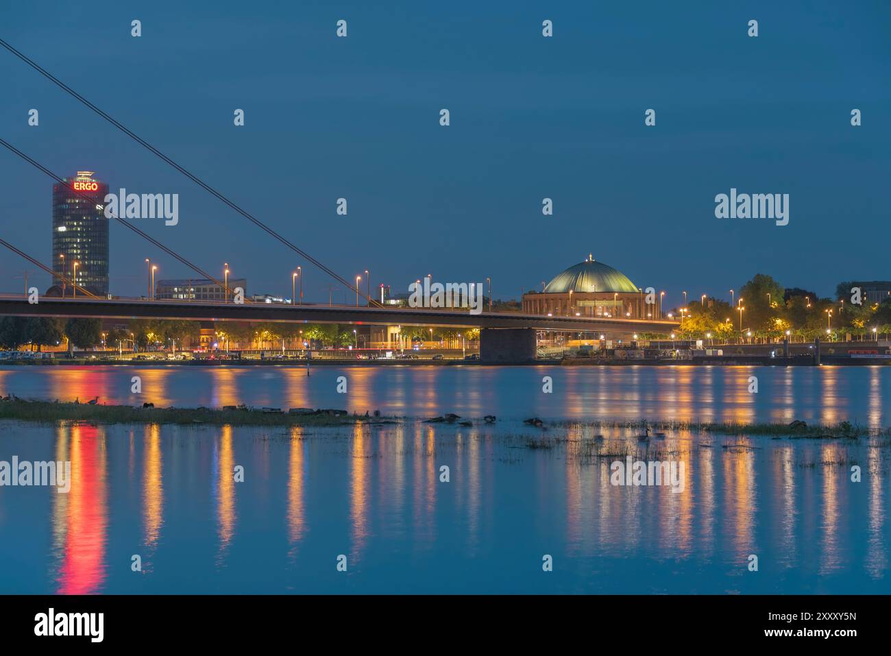 Vue nocturne sur le Rhin en direction de l'Oberkassler Brücke (pont), de la Tour Victoria et de la salle de concert Tonhalle à Düsseldorf, en Allemagne Banque D'Images