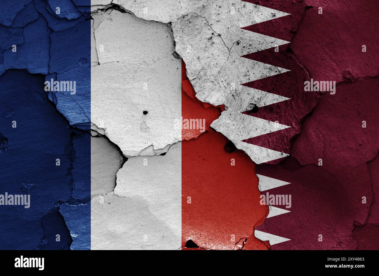 Drapeaux de France et du Qatar peints sur un mur fissuré Banque D'Images