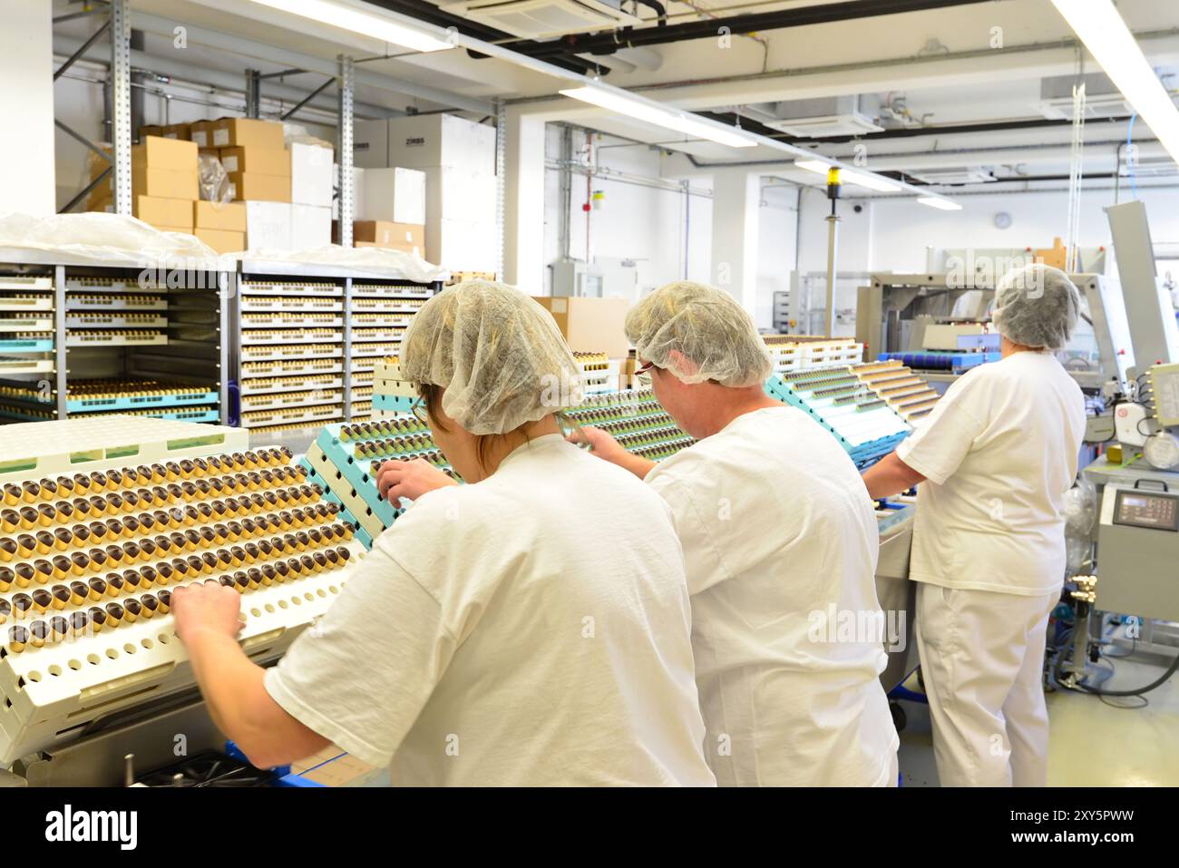 Production de pralines dans une usine pour l'industrie alimentaire - courroie de convoyeur automatique avec du chocolat Banque D'Images