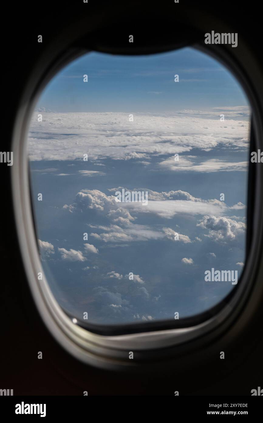 Vue des nuages et de l'horizon depuis la fenêtre du plan. Banque D'Images