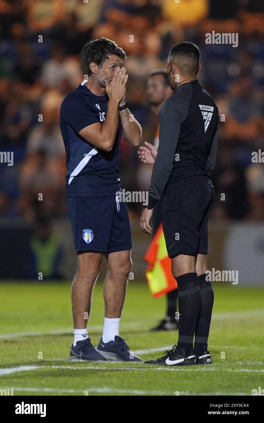 L'entraîneur de Colchester United, Danny Cowley (à gauche), se plaint au quatrième officiel après que Brentford ait marqué son premier côté du but lors du match de deuxième tour de la Coupe Carabao au JobServe Community Stadium de Colchester. Date de la photo : mercredi 28 août 2024. Banque D'Images