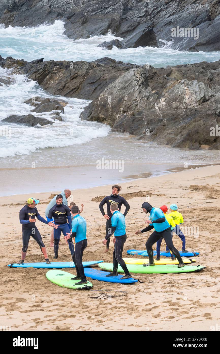 Des instructeurs de surf guident les enseignants du Surf Sanctuary enseignant un groupe d'apprenants novices de surf sur Fistral Beach à Newquay en Cornouailles au Royaume-Uni Banque D'Images