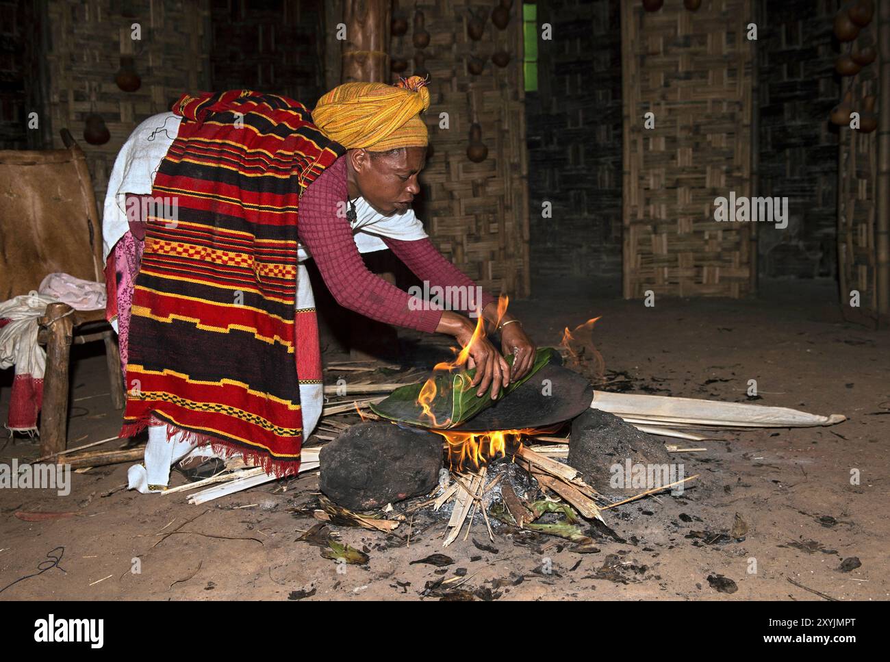 Femme Dorze cuisinant du pain Kotcho à partir de parties de la banane abyssinienne (Ensete ventricosum) au-dessus d'un feu de bois ouvert, près d'Arba Minch, en Éthiopie Banque D'Images
