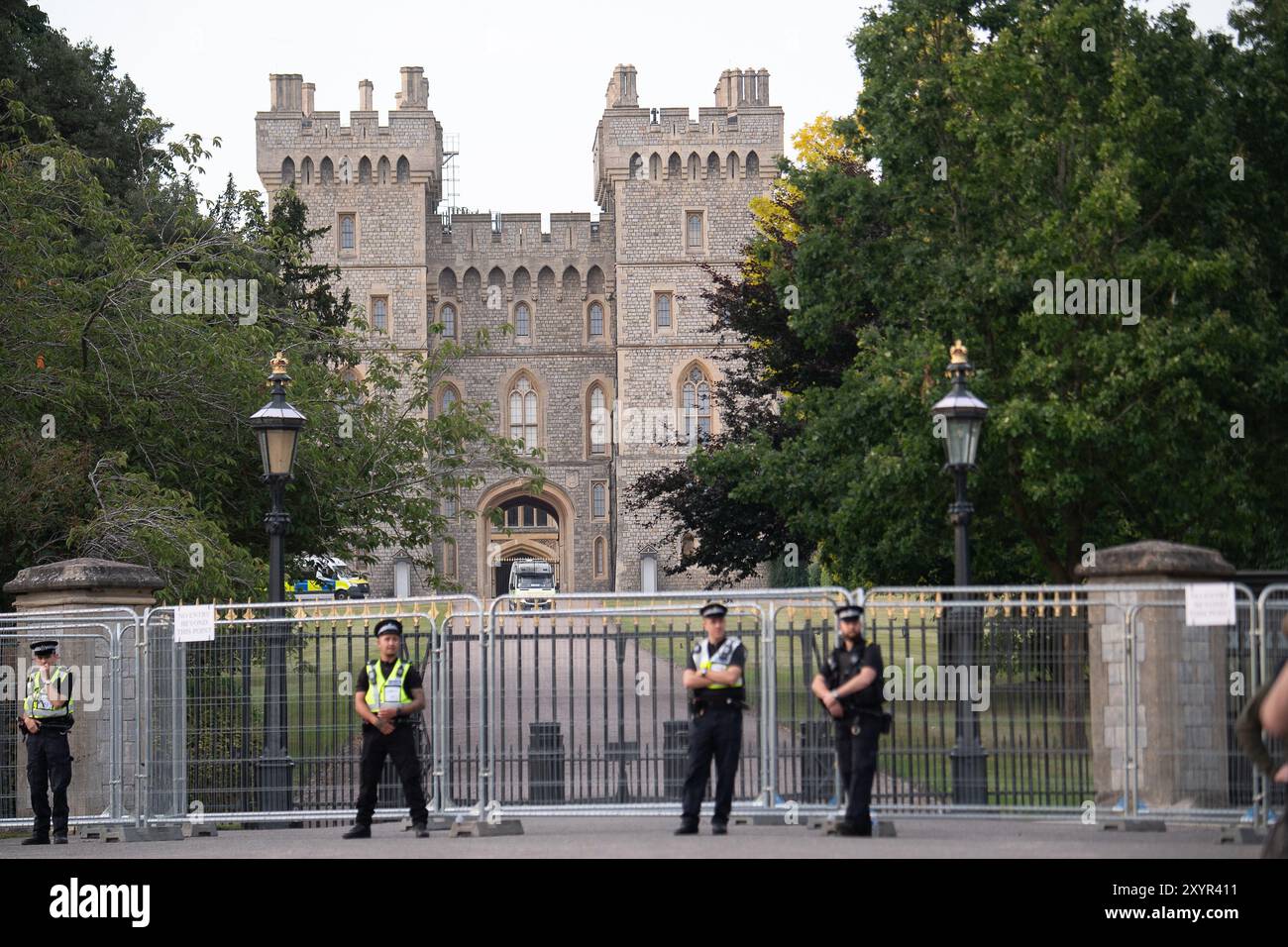 Windsor, Royaume-Uni. 30 août 2024. Extinction Rebellion a organisé une manifestation sur la longue marche avec pour toile de fond le château de Windsor à Windsor, Berkshire ce soir. Les manifestants climatiques de XR portaient des costumes d'affaires et s'habillaient en barons du pétrole, en magnats des médias et en financiers sans visage. Les Oil Slicks, habillés de costumes noirs avec de la peinture de visage noir et blanc, ont réalisé une action théâtrale chorégraphiée dans le but de mettre en évidence le récit XR pour la journée, que le système est brisé. Les rebelles XR campent à Home Park en face du château de Windsor aujourd'hui et pendant le week-end dans le cadre de leur surclassement de trois jours Banque D'Images