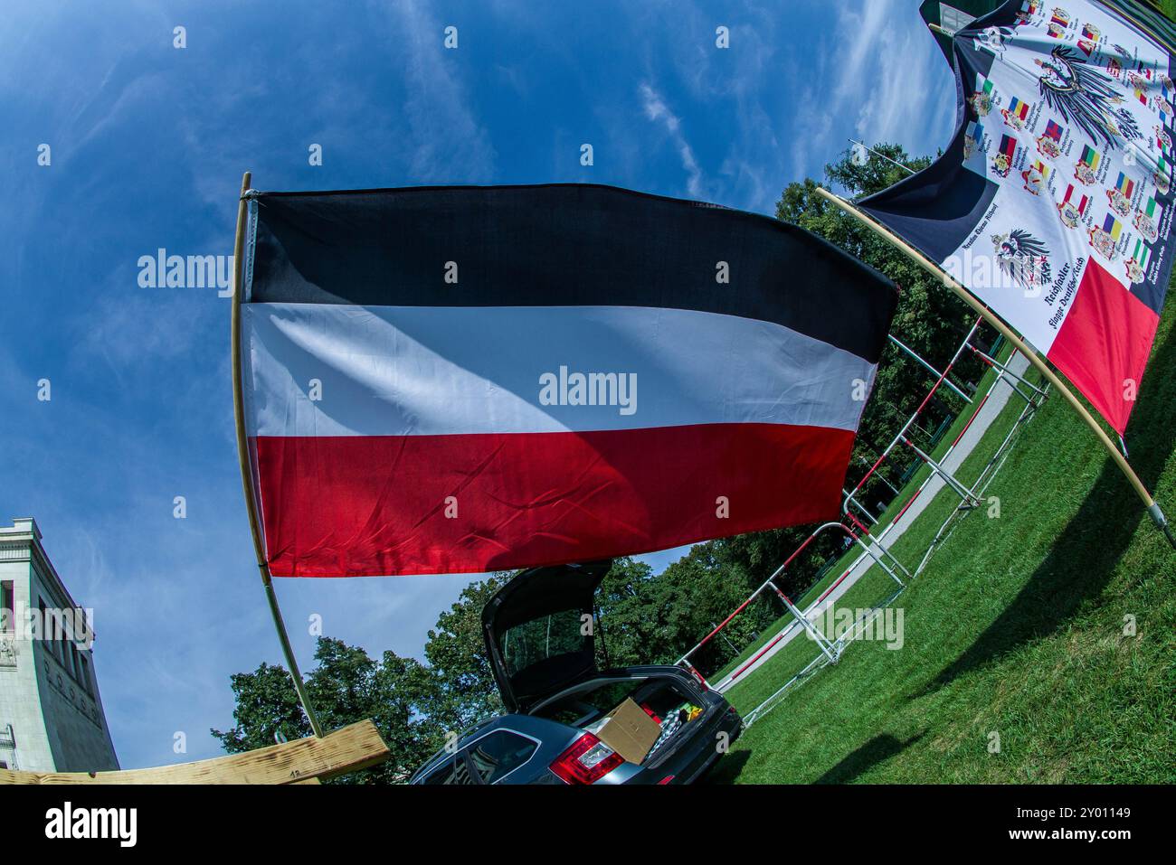 31 août 2024 : sous le nom de 'Grosser Treffen der 25 1 Bundesstaaten'', Reichsbuerger (ReichsbÃ¼rger, citoyens souverains, citoyens du Reich) s'est réuni sur la Koenigsplatz de Munich pour établir un réseau et nier la légitimité de la république allemande. Les Reichsbuerger ont été à l'origine banalisés et transformés en comédie dans les médias contre les avertissements de radicalisation par des experts jusqu'à ce qu'un raid à Georgesmund entraîne la mort d'un policier. L'affaire a également révélé Reichsbuerger dans la police et les structures étatiques mêmes dont ils nient la légitimité. À Munich, de nombreux Reichsbuerge connus Banque D'Images