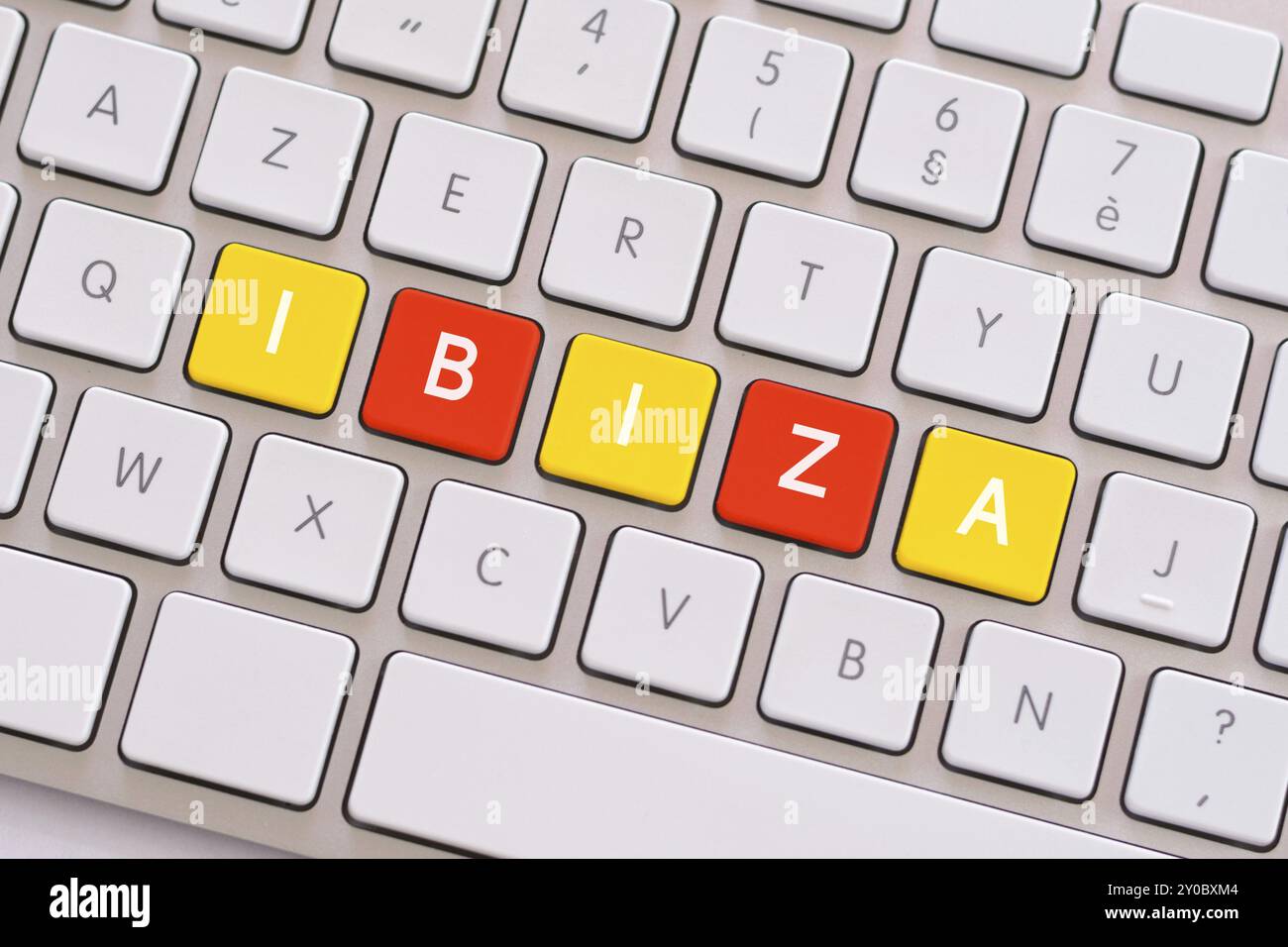 Ibiza en jaune et rouge sur le clavier blanc Banque D'Images