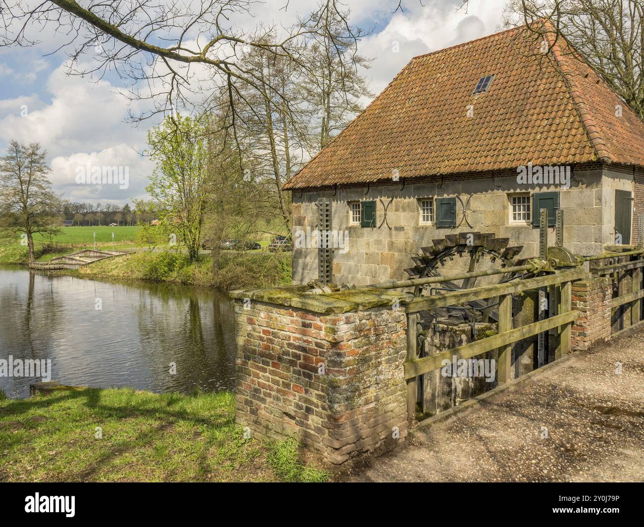 Ancien moulin en pierre avec pont et roue à eau sur un paysage fluvial dans un cadre de source naturelle, Eibergen, Gueldre, pays-Bas Banque D'Images